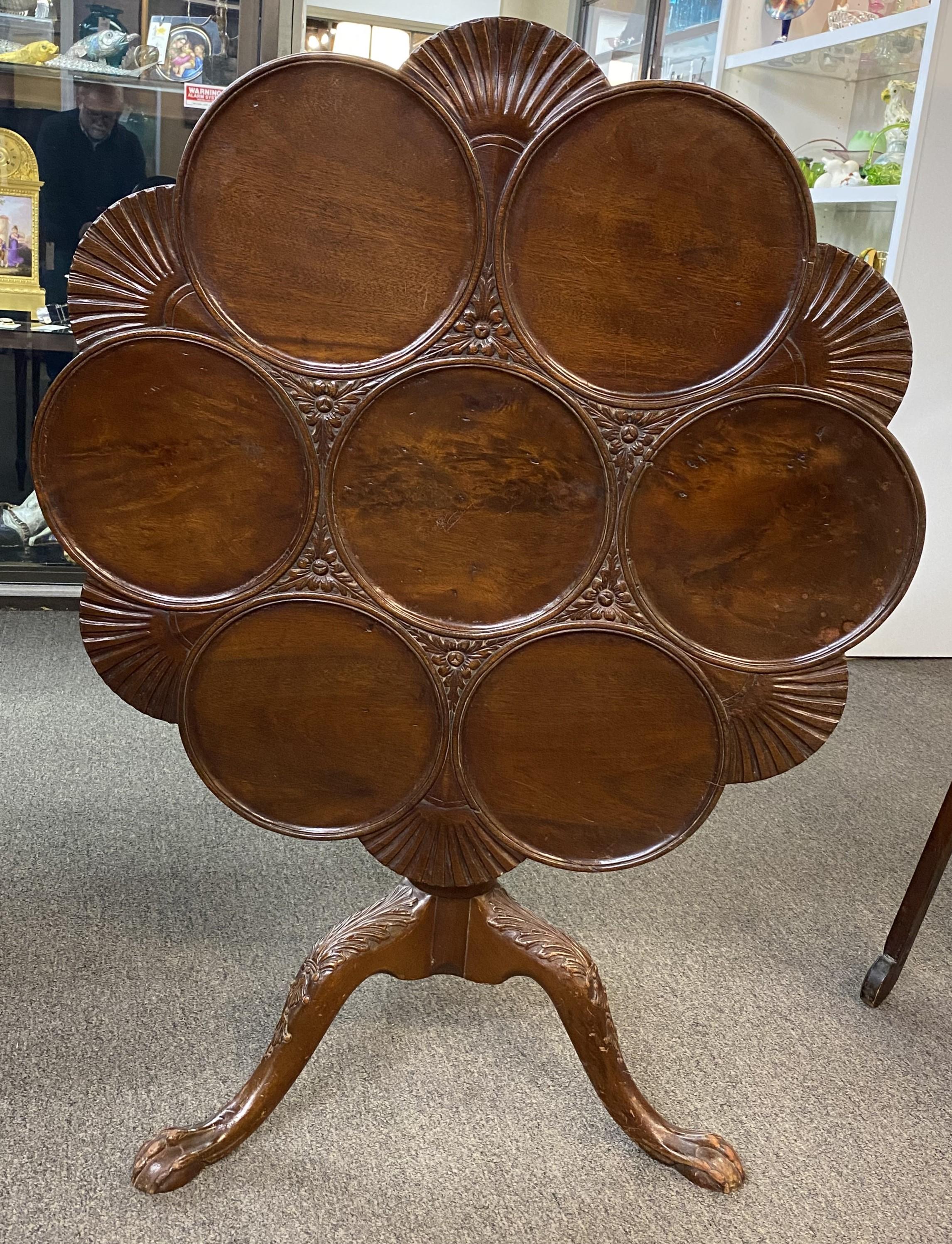 A wonderful English George III mahogany tilt top supper table circa 1785 with shell carvings on a foliate carved pedestal and tripod legs, terminating with ball & claw feet. Very good overall condition, with some minor repairs, restorations, surface