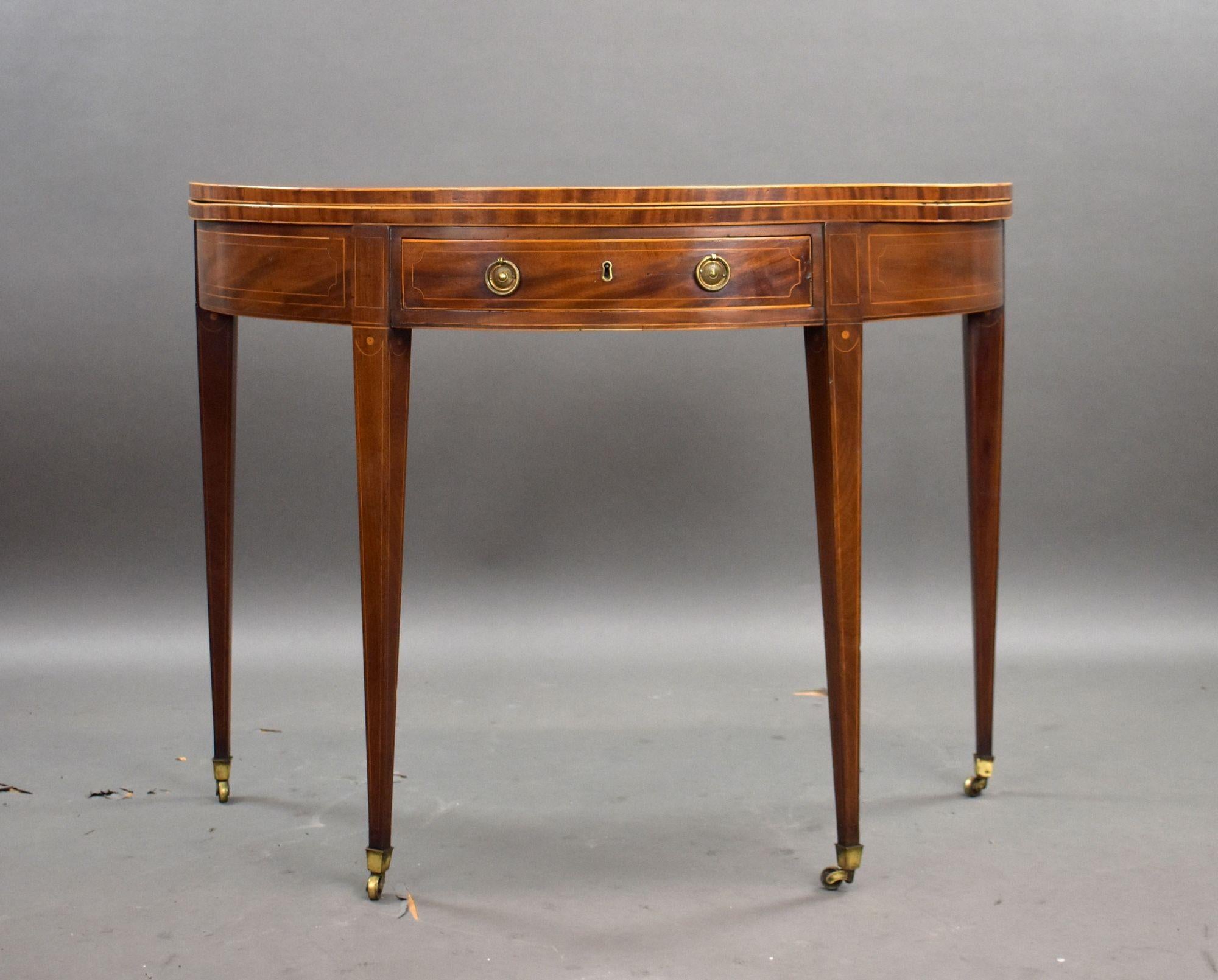 George III Mahogany Tea Table
Item Code: 1052
A fine George III mahogany tea table of demi-lune form, dating from the late 18th century. The hinged fold-over top opens to reveal a polished interior surface, supported by a rear gateleg action,