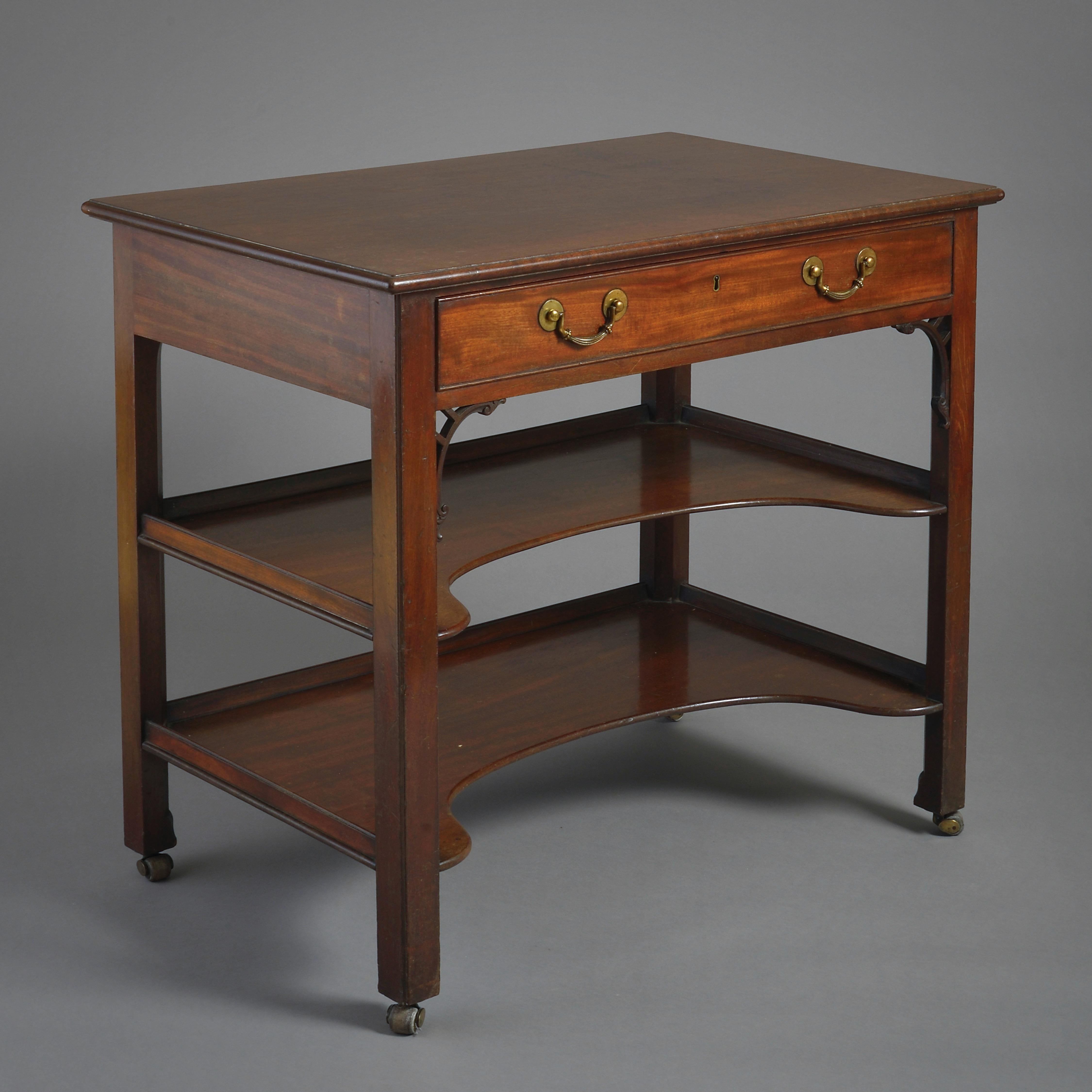 A fine George III mahogany three-tier side table, circa 1760.

With finely figured top above a frieze drawer, scroll brackets, and two concave galleried under-tiers on square chamfered legs. Handles original.