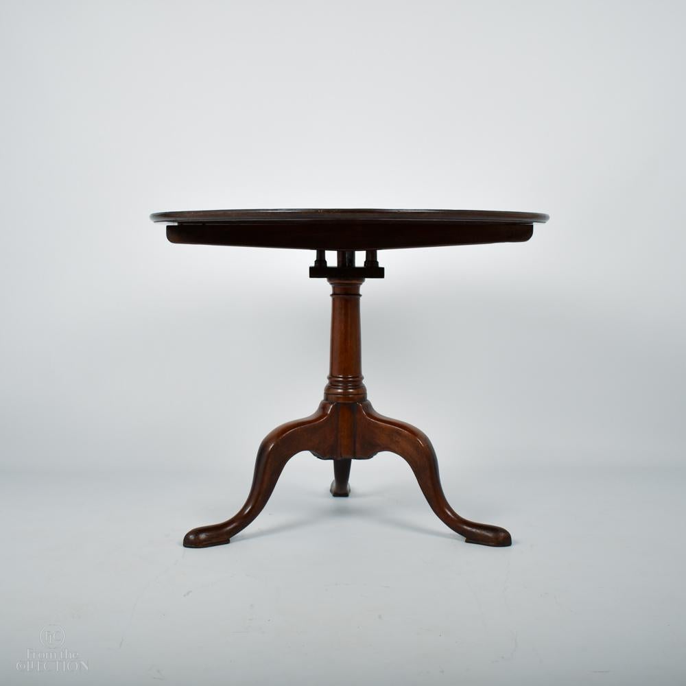 George III Mahogany extremely fine quality tilt top table circa 1780 with the typical birdcage mechanism beneath giving it the extra support to hold the wide top that fully rotates. On a turned mahogany column down to three splayed legs on pad feet.