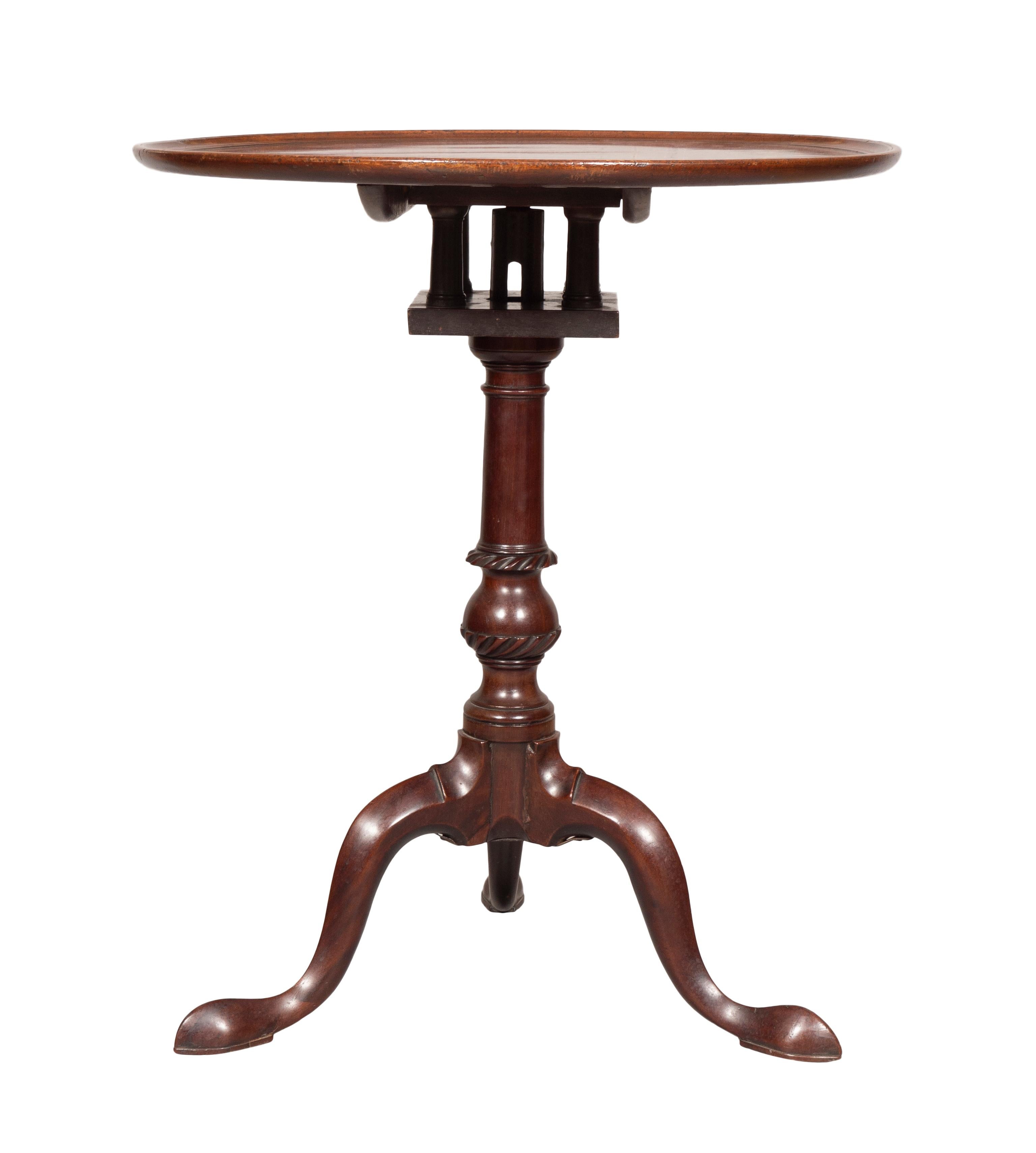 Circular dished top with hinged bird cage and carved and turned support joining three cabriole legs ending on pad feet.