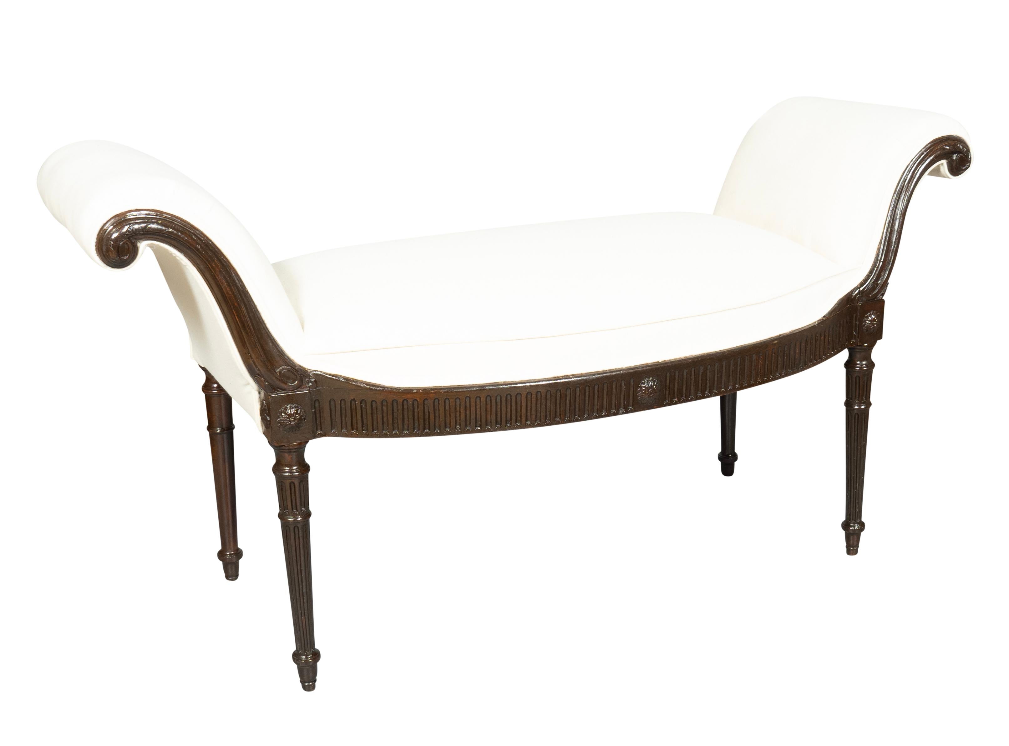 Rectangular with scrolled ends. Newly upholstered in muslin. Fluted seat rail and circular tapered fluted legs.