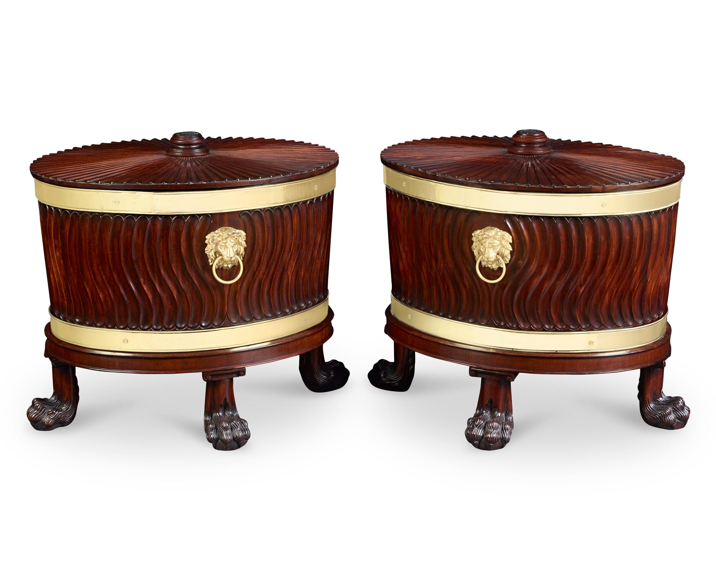 This rare and important pair of George III mahogany wine coolers epitomizes the graceful Neoclassical aesthetic championed in the Georgian style. Crafted of the finest quality mahogany, the coolers retain their original zinc liners. The top of the