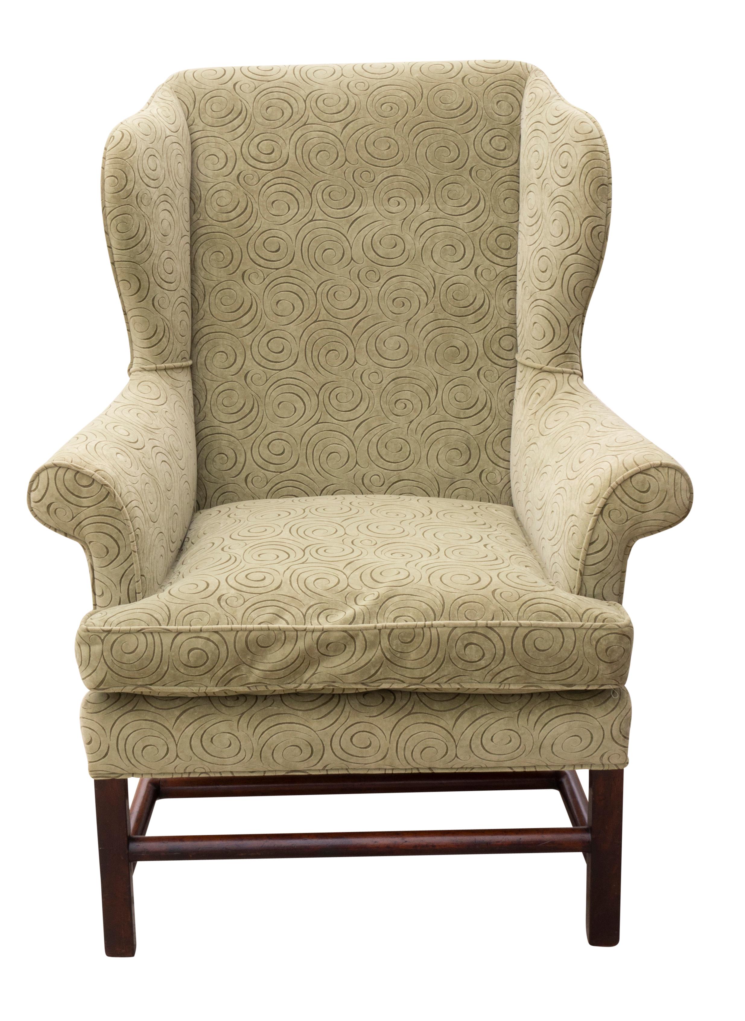 Typical form with atypical cylindrical stretchers. Square tapered legs. Upholstery in good condition.