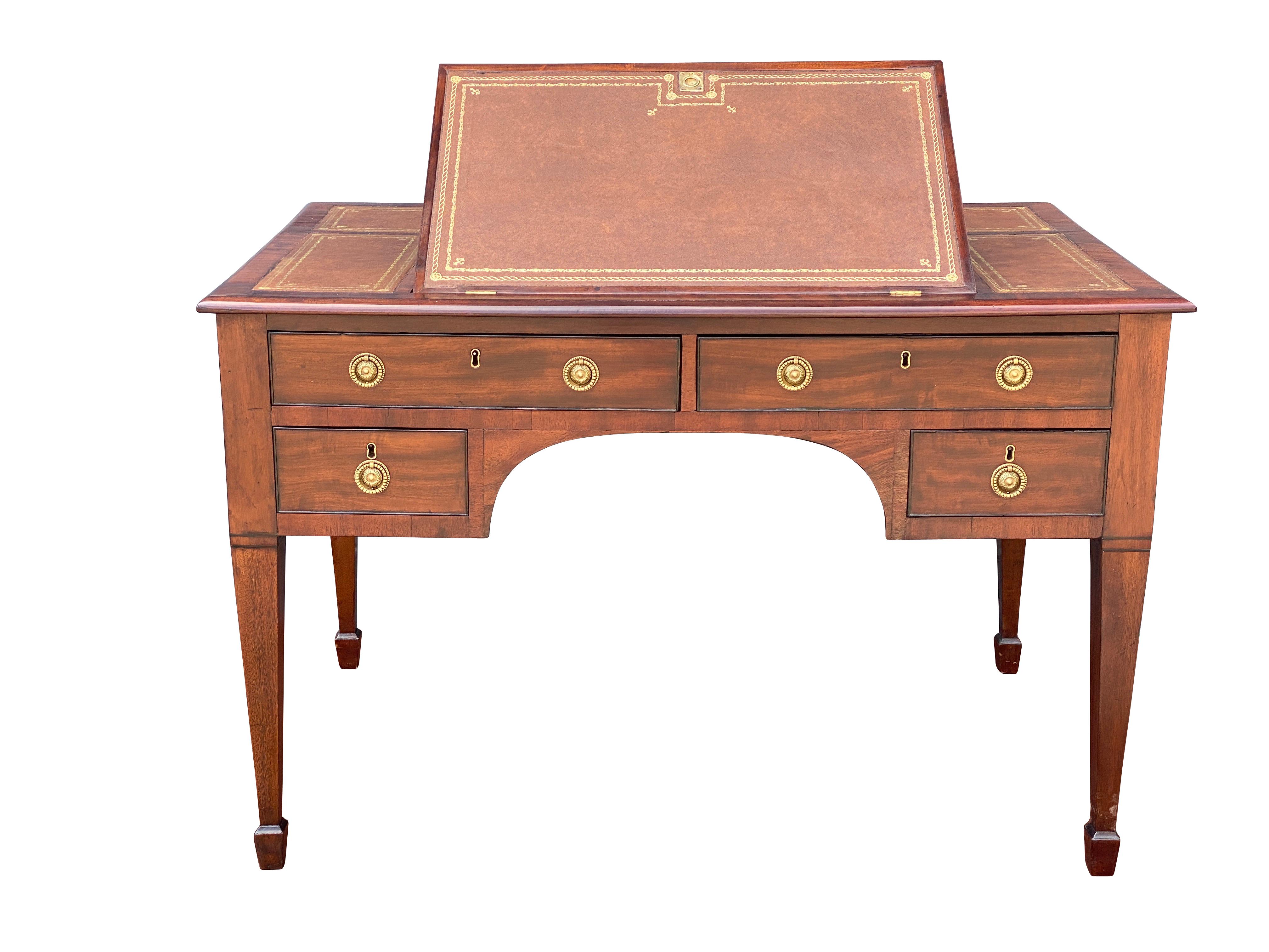 Rectangular top with all new olive tooled leather and central hinged rest, over a pair of drawers over two small drawers, raised on square tapered legs with spade feet. The back is plain but finished.