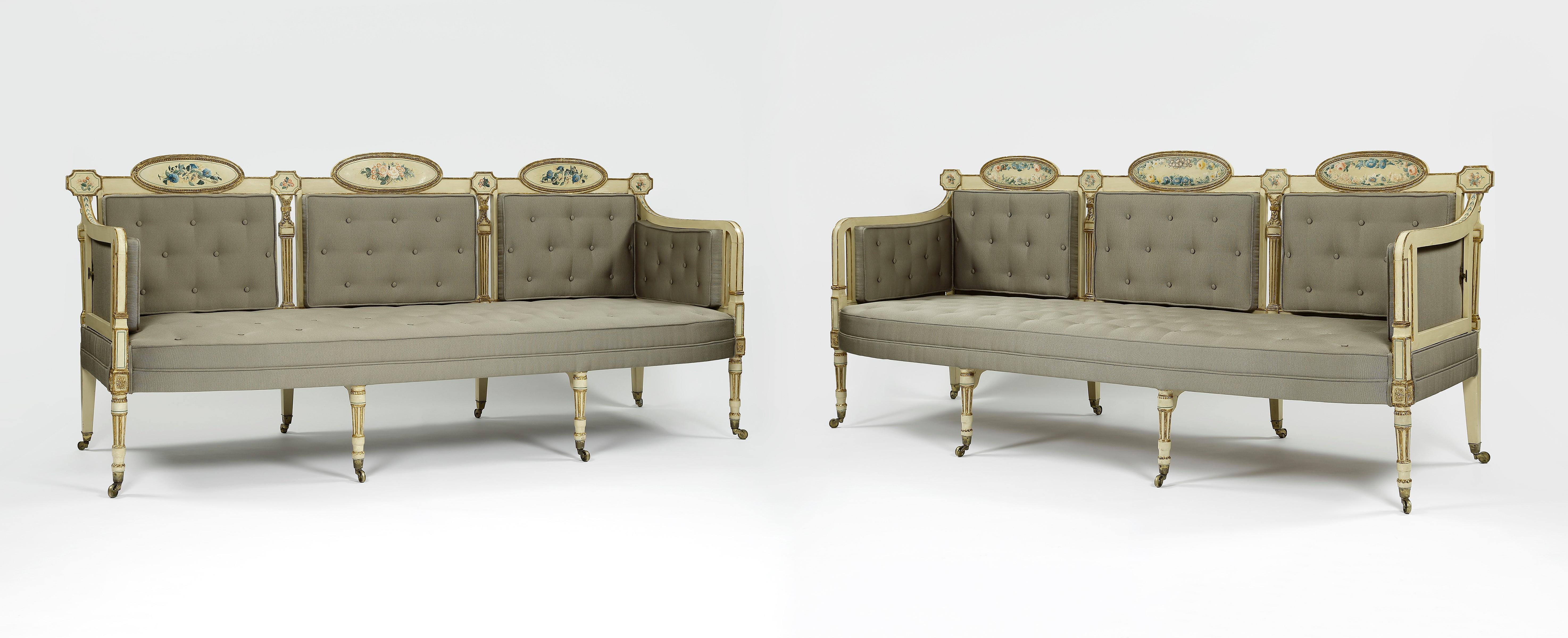 An outstanding pair of cream ground and gilt decorated settees in the Neo-classical design. Having four turned carved and reeded front legs, which are all raised on casters. The backs of the settee have finely decorated small panels and large ovals,