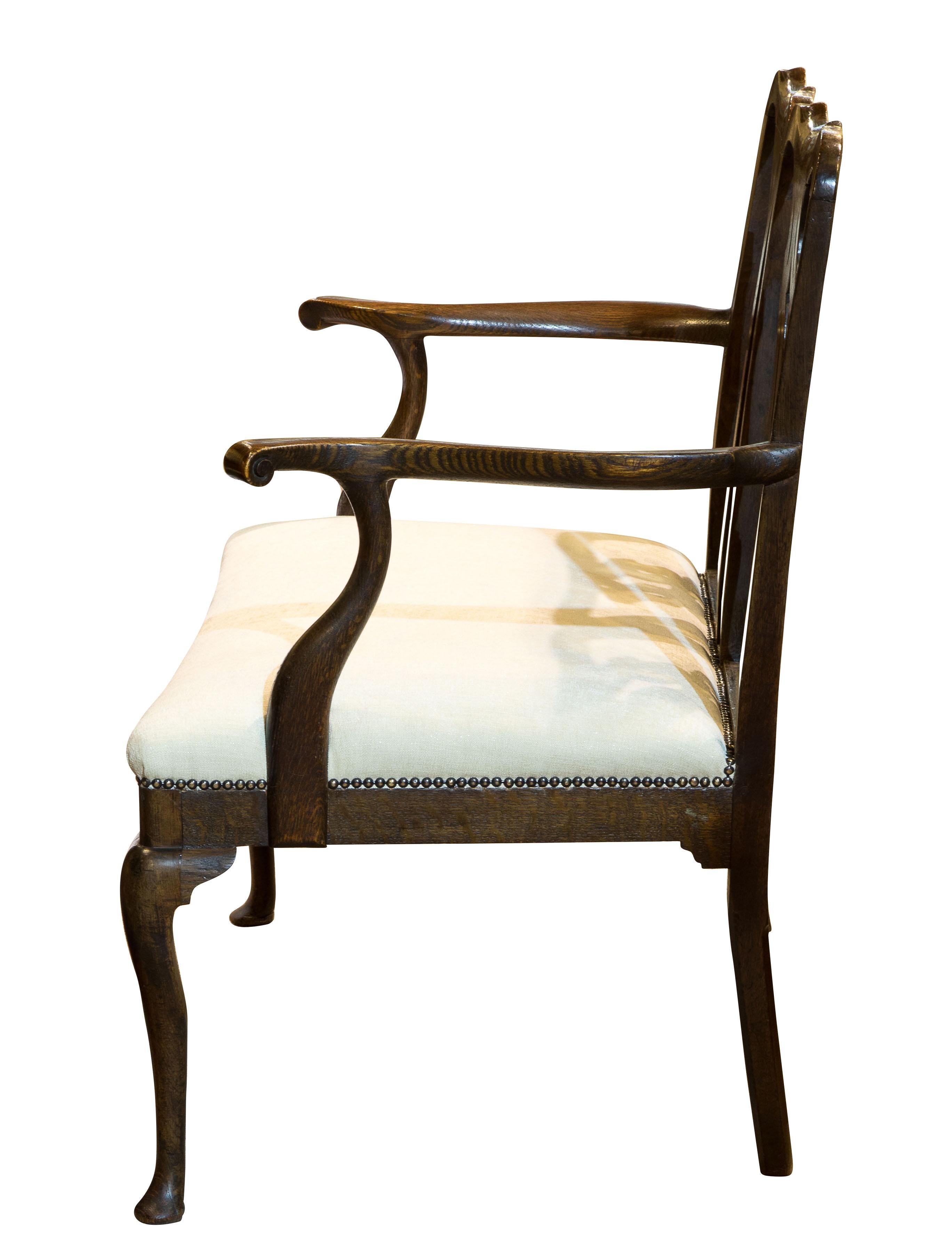 George III oak chair-back two-seat settee. (Newly upholstered).
