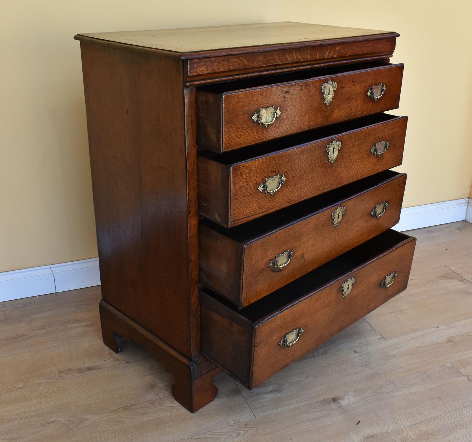 For sale is a good quality George III oak chest of drawers. The top of the chest has a banded top, above an arrangement of four graduated drawers, each with brass handles and escutcheons. This piece stands on bracket feet and is in very good