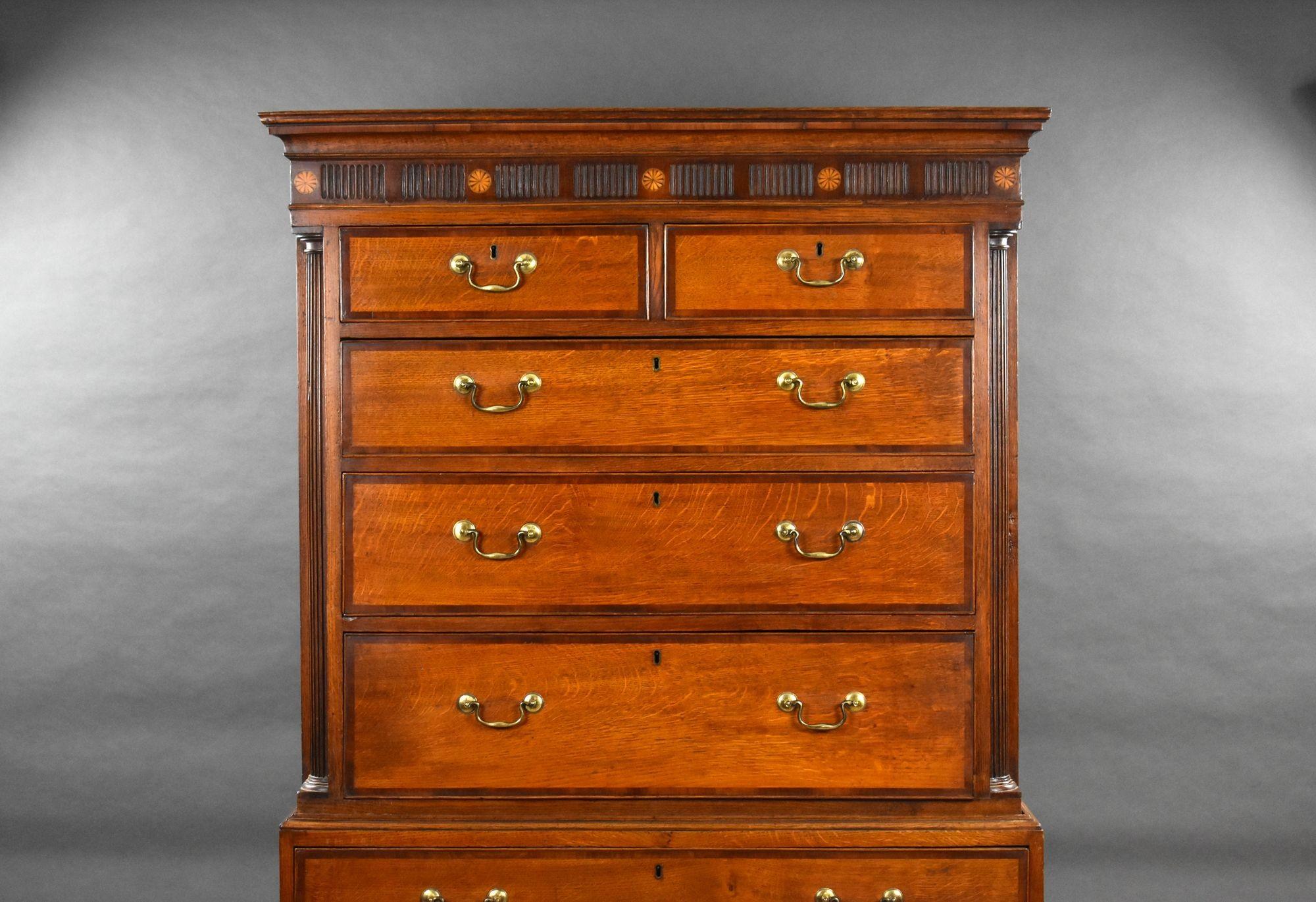 For sale is a good quality Georgian oak and fruitwood crossbanded chest on chest, with a moulded cornice and patera inlaid reeded frieze, having two short over over six graduated drawers, standing on bracket feet, the chest remains in excellent