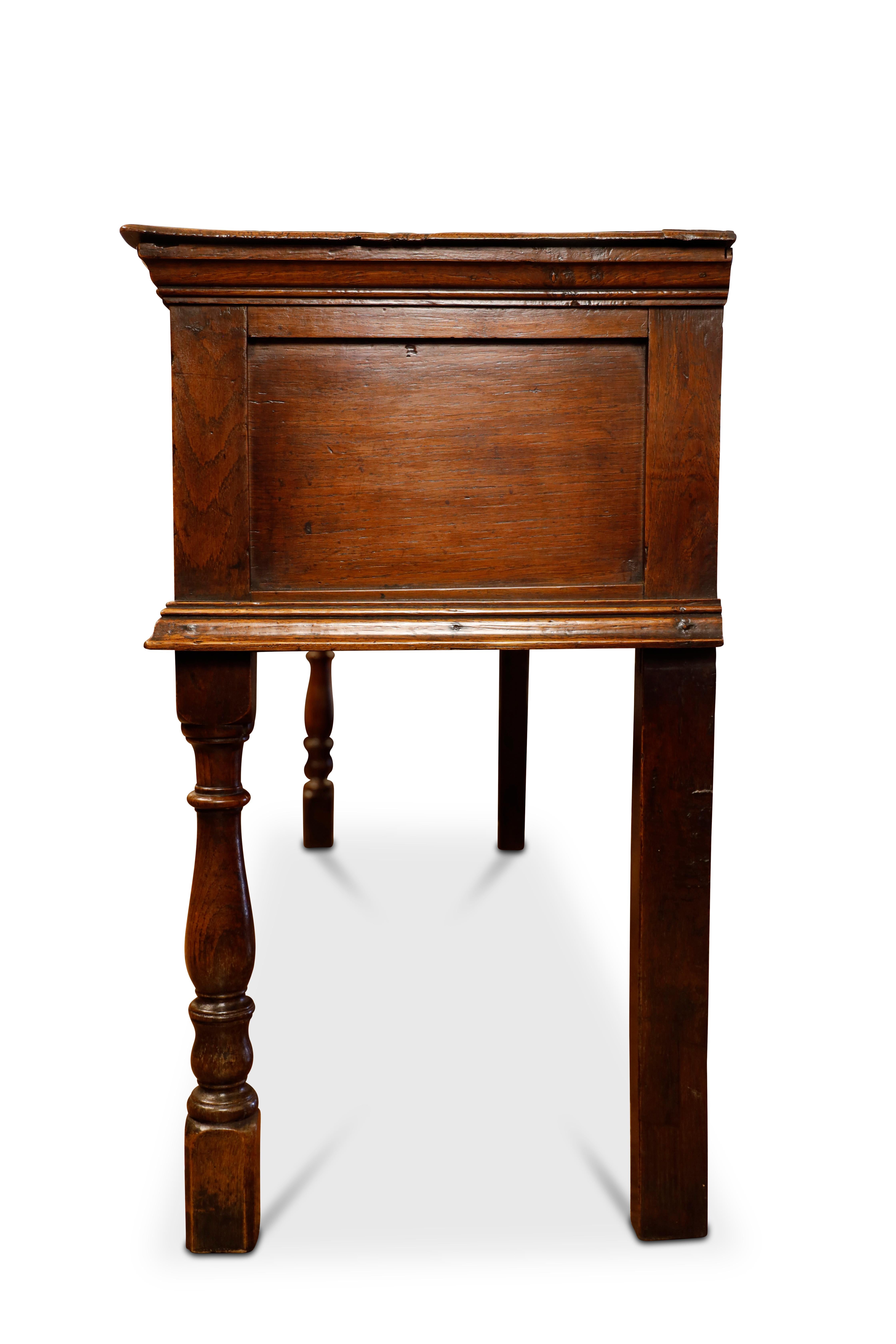 George III oak dresser base with three drawers, turned front legs with fret corner brackets; straight back legs.