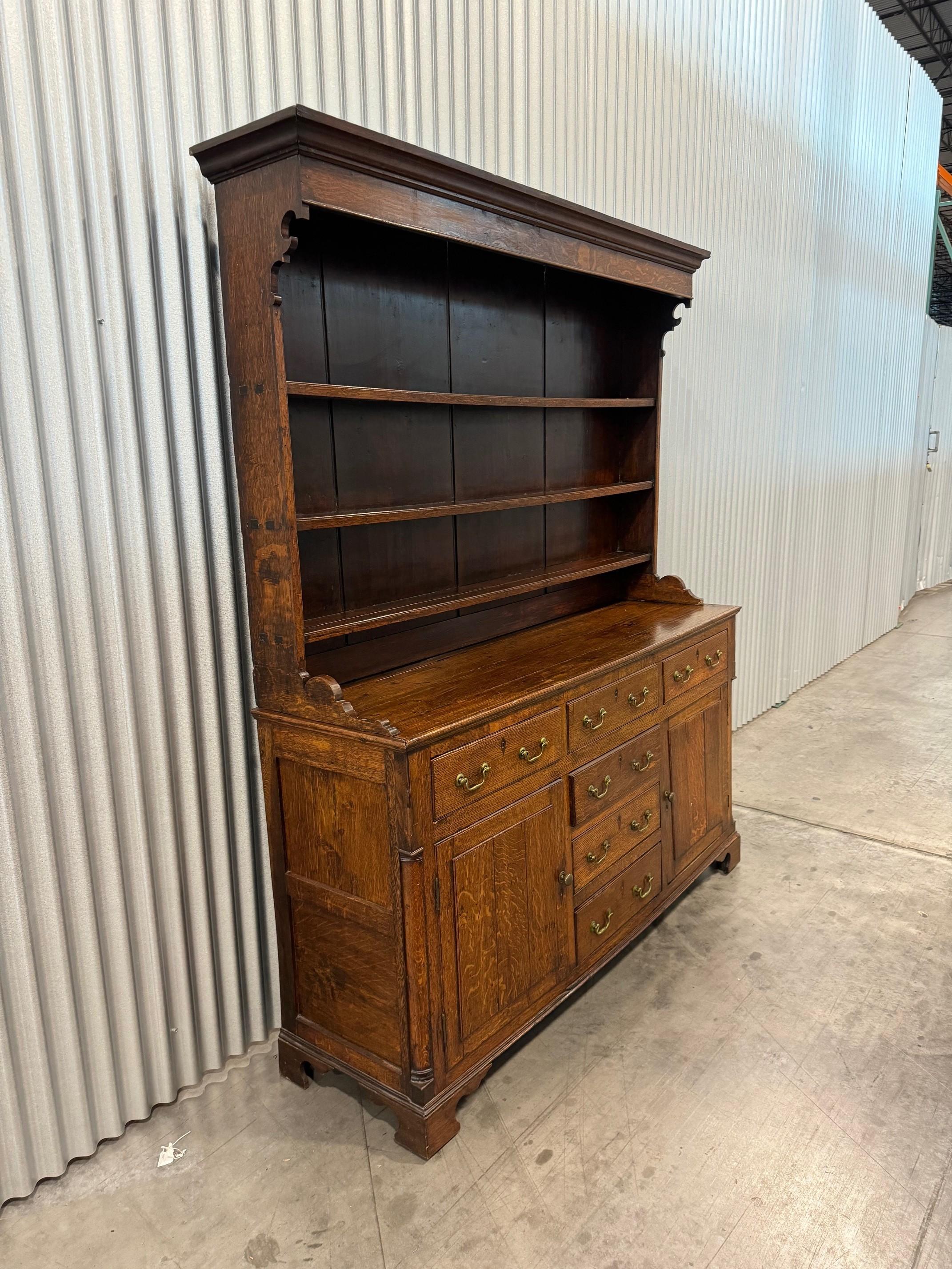A lovely George III oak dresser, the shelf back above six drawers and two doors, height 81