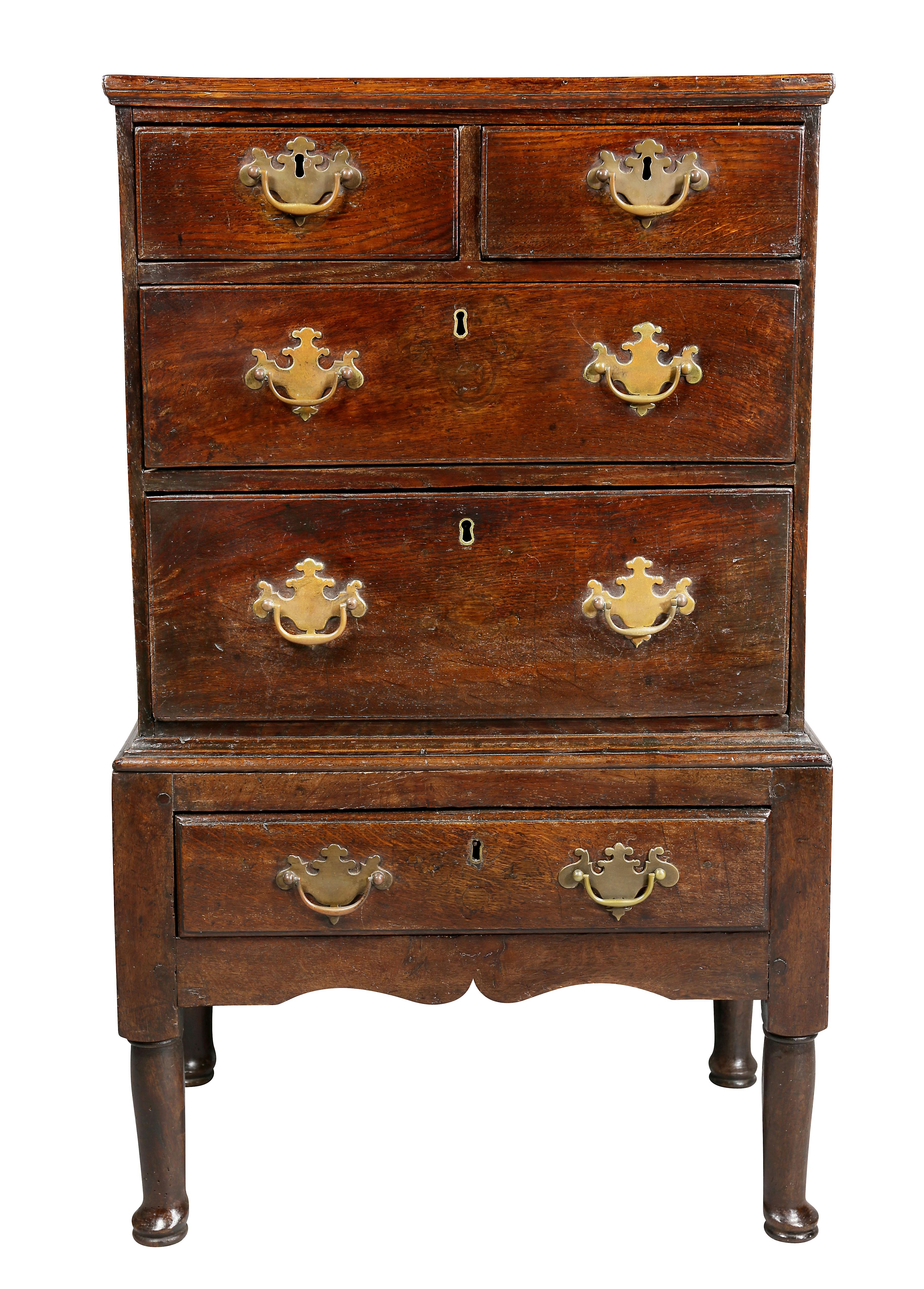 With rectangular top over two over two long drawers, the base with a single drawer raised on turned legs and pad feet. Unusual small size.