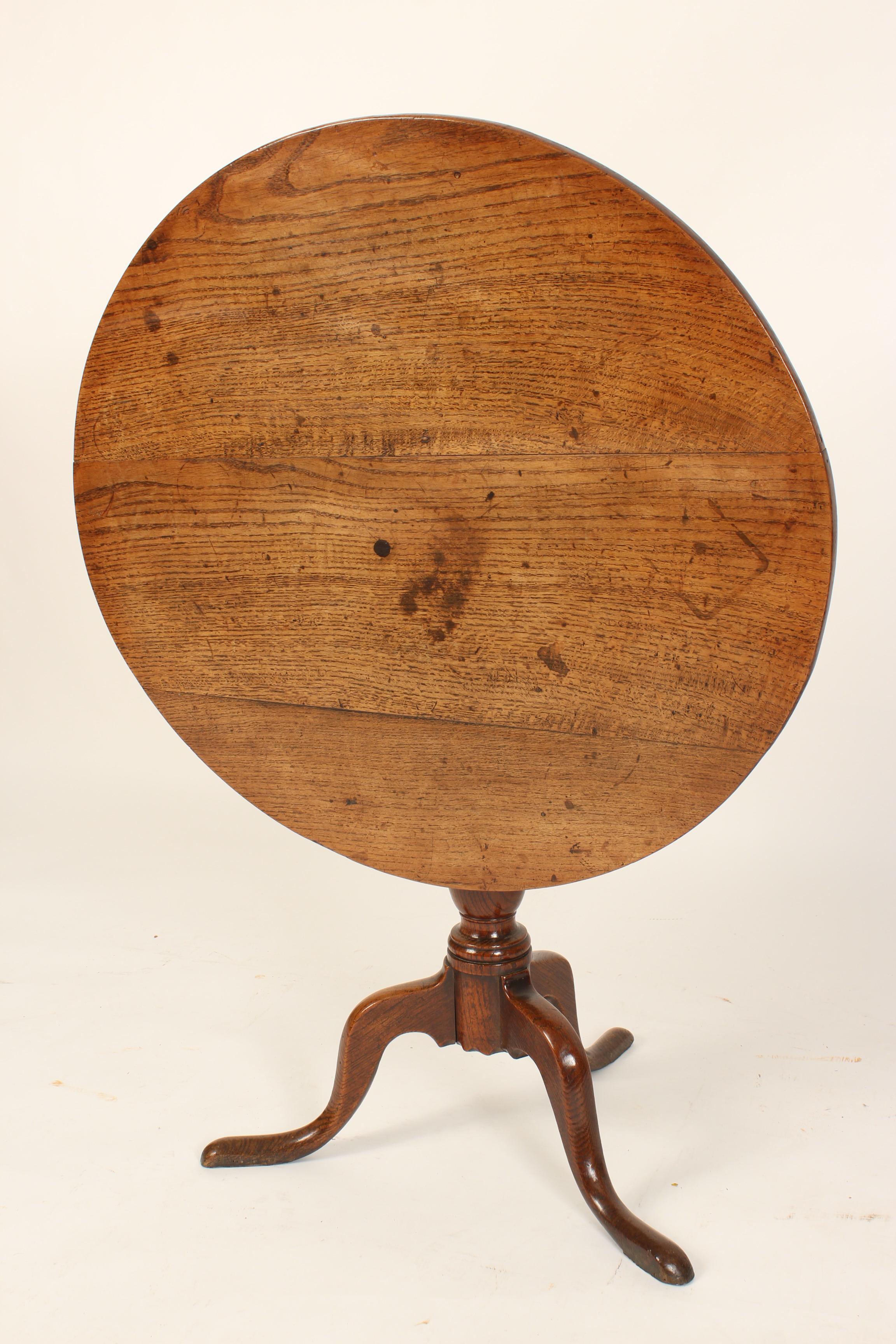 George III oak tilt top table, circa 1780. This table has a nice old patina. The table was formerly sold by Richard Gould Antiques, Santa Monica, Calif. Height when the tilt top is raised 44.5