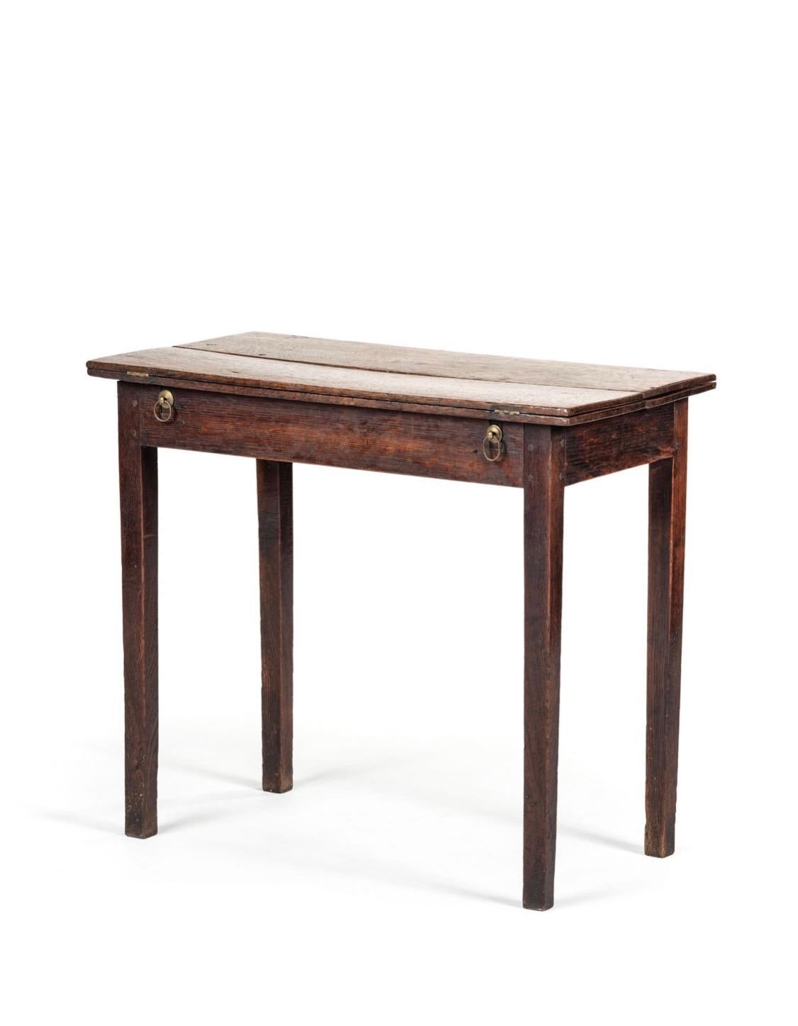 George III oak writing table, 18th Century
A small and simple rectangular table with folding top. Two arms pull out and each side of table to hold opened tops on either side. 
Slight warp and bow. Wear to surface and legs. Structrually