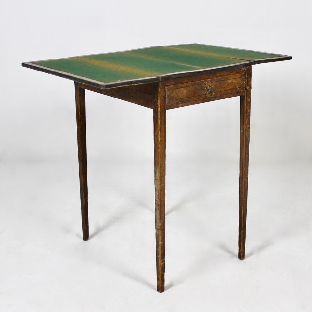 The most wonderful and rare George III period original painted pine card / occasional table. The whole retaining its original paint, the faux decorated marble top opening to reveal a baize lined interior, the simulated satinwood frame work with