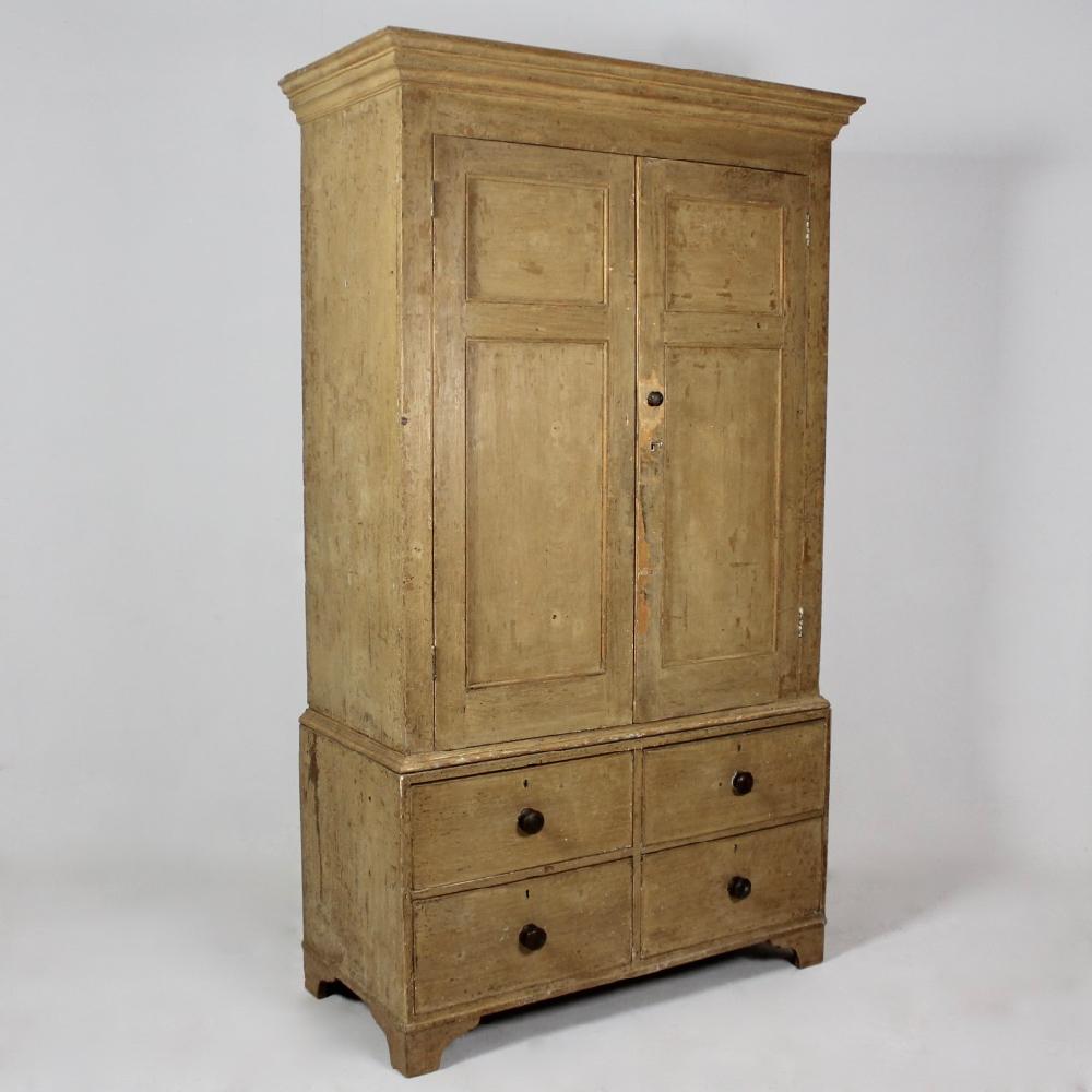 A wonderful George III period pine press or kitchen cupboard of elegant low waisted proportions. With four drawers, three shelves and standing on bracket feet, the whole dry scraped back to its original paint. Two shelves are later, the originals