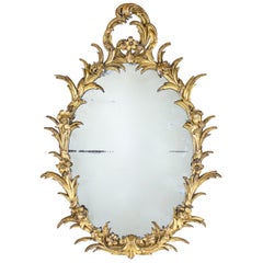 George III Oval Mirror with a Carved Giltwood Floral Frame