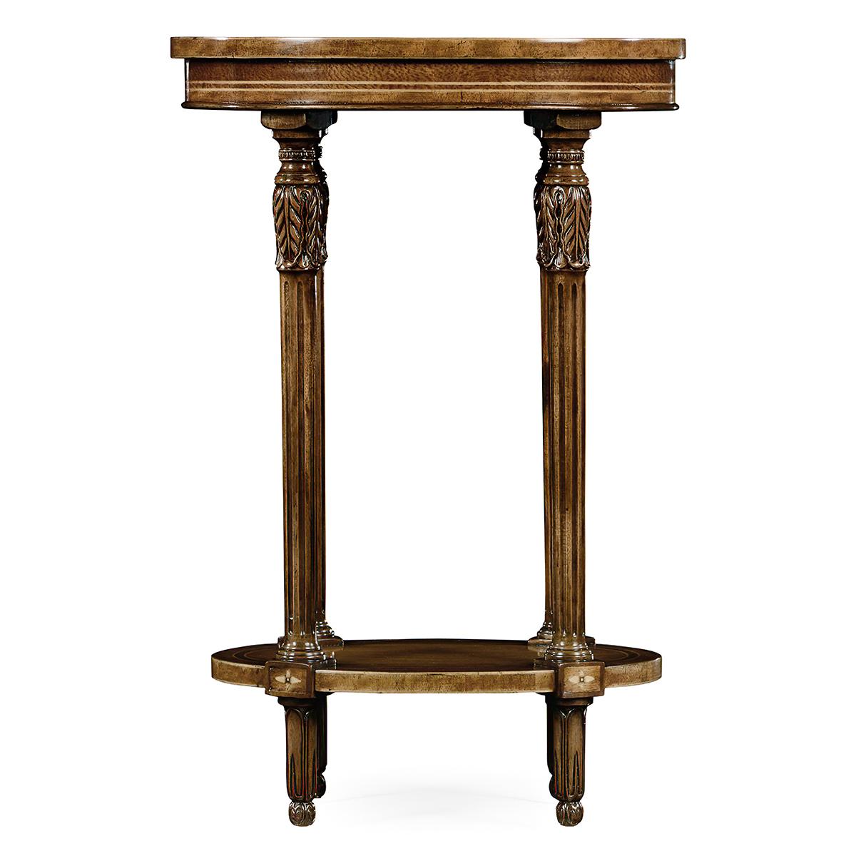 Elegant George III style oval two-tier wine table with fine crossbanded inlays and delicate carving to the fluted columns with oval shelf stretcher. 

Dimensions: 17.75