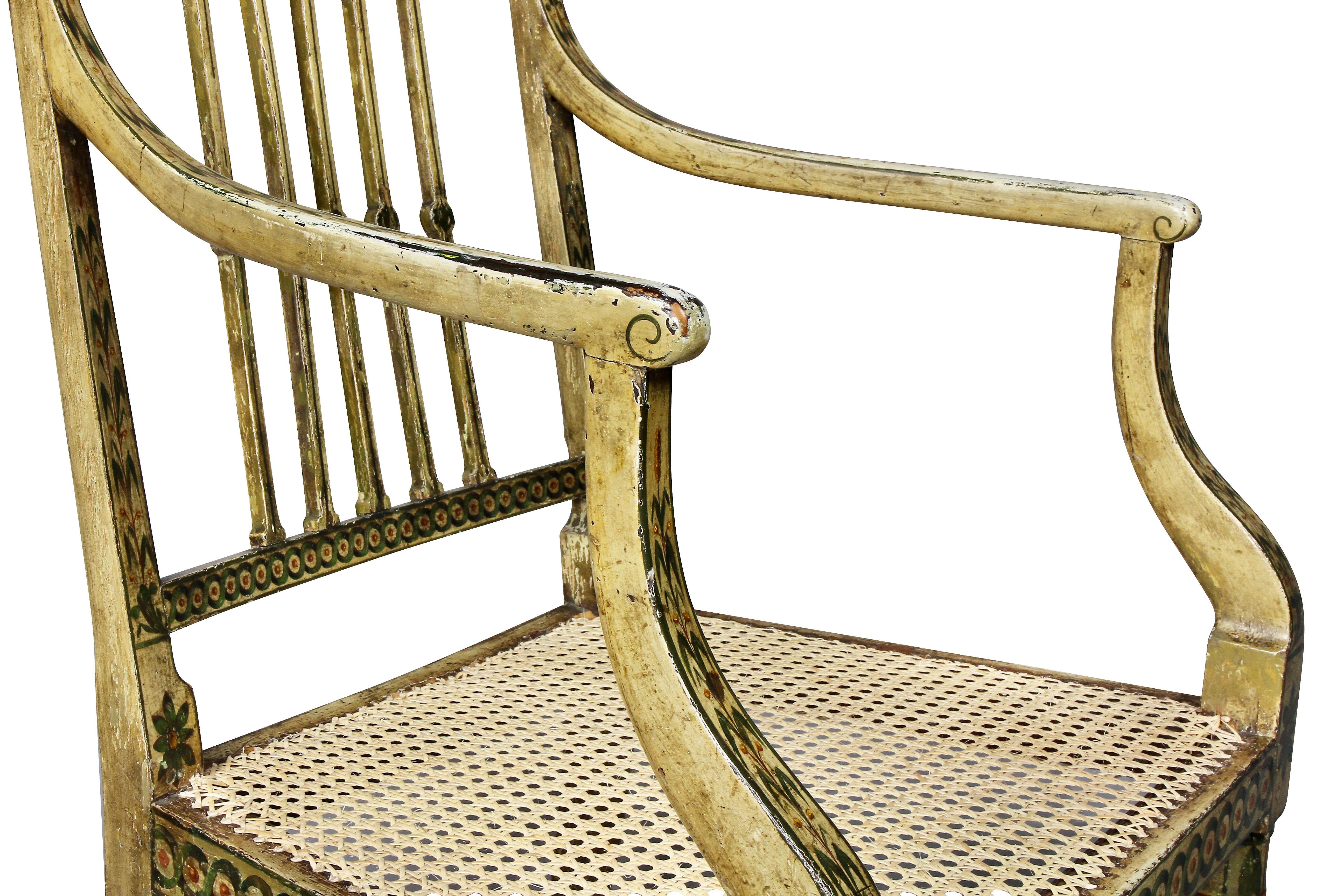 Square back with vertical slats, caned seat, shaped arms, raised on circular tapered legs. Drue Heinz Estate. Seat newly caned.