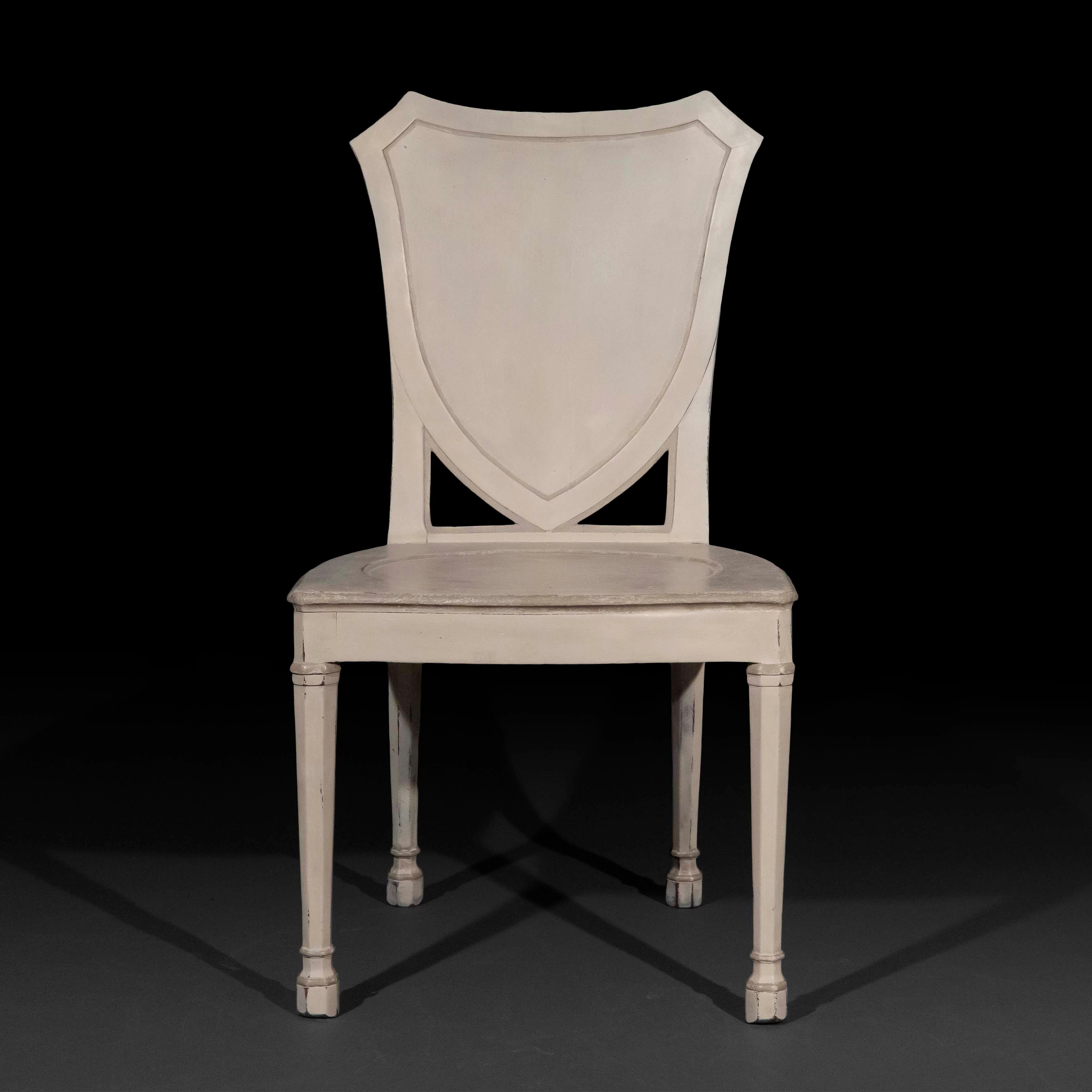 A rare and unusual George III period painted hall chair of large proportions,
England, circa 1780.

Why we like it

A very decorative and well-drawn chair, undoubtedly from an important suite. We like the unusual, octagonal-profile legs, the