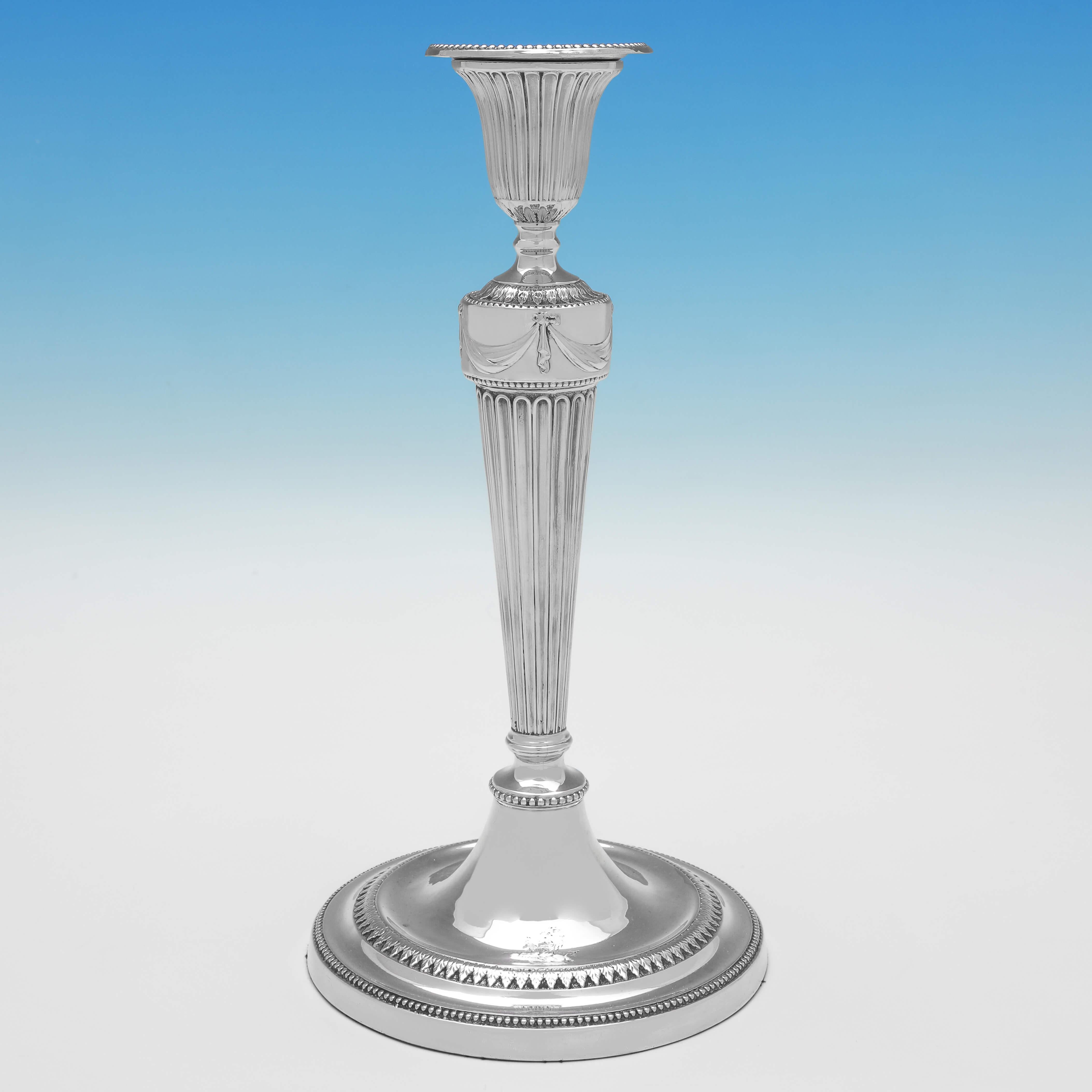 Hallmarked in Sheffield, 1781 by John Winter & Co. This wonderful, George III, Antique, Sterling Silver Pair of Candlesticks, feature bead borders, sunken fluting, acanthus decoration to the bases and capitals, engraved crests, and swags and bows