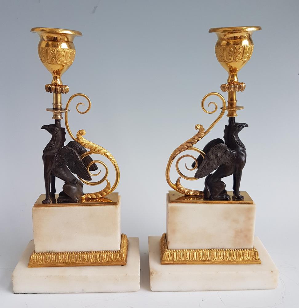 An extremely fine pair of George III ormolu and marble chambers pattern griffin candlesticks. In the famous William Chambers pattern. Sir William Chambers was the court architect to George III and produced many designs for Matthew Boulton. These are