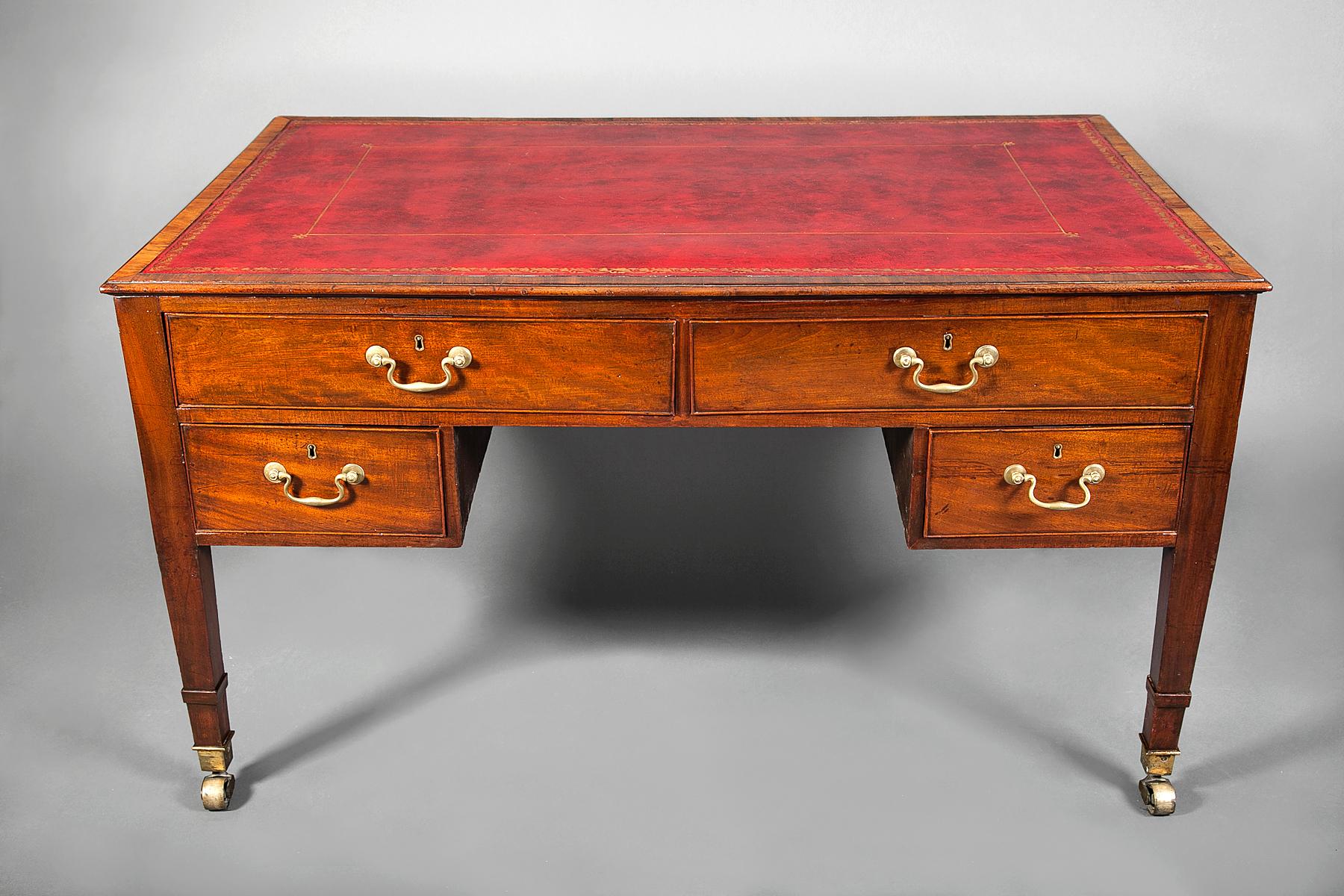 George III partners desk. Red leather and gilded trim top with bronze mounts. Four drawers on one side five drawers on the other.