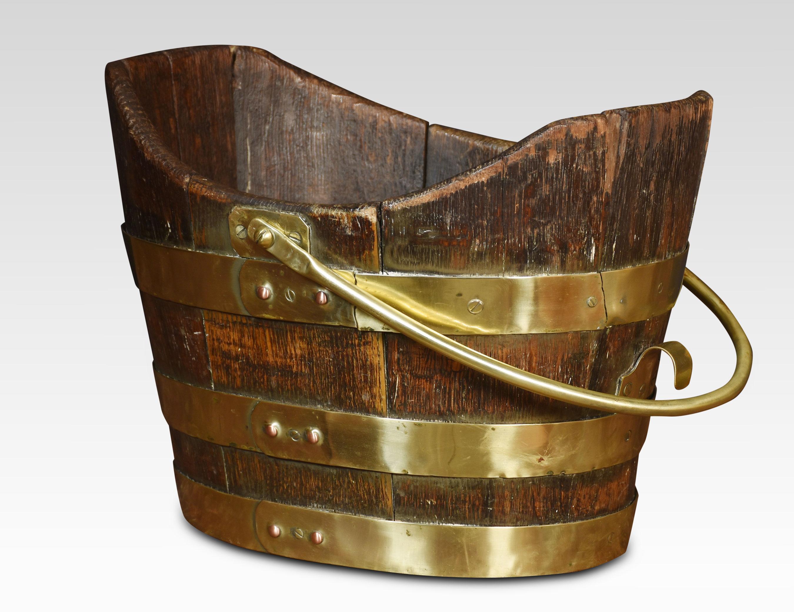 George III peat bucket with handle above the oak frame encased in brass bands.
Dimensions
Height 10.5 Inches
Width 15 Inches
Depth 12 Inches