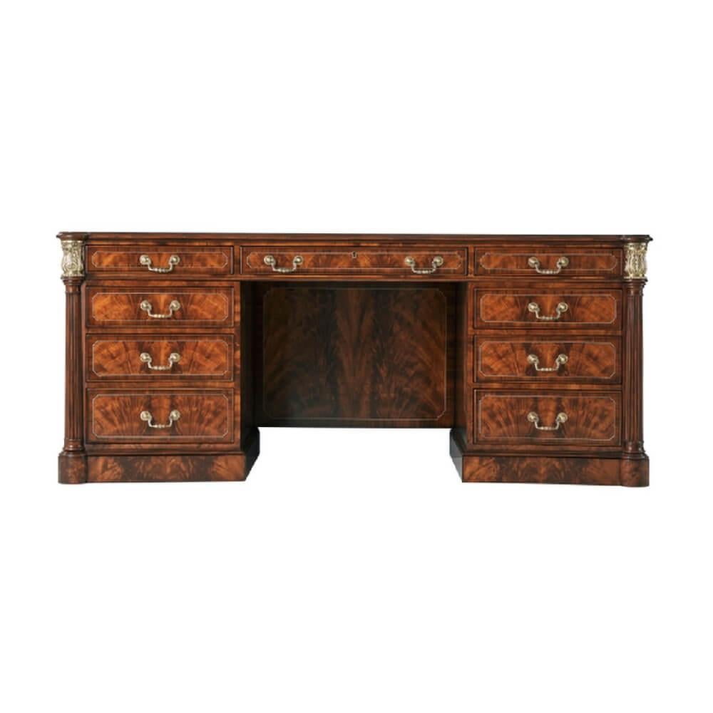 A fine George III style mahogany leather top pedestal desk, with a flame mahogany veneered and crossbanding to the top, with fine double stringing details, the gilt-tooled leather inset concave sided top with protruding rounded corners supported by