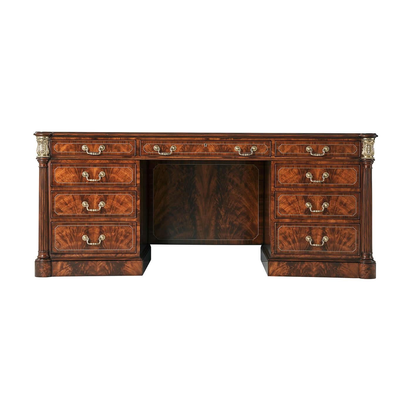 A fine George III style mahogany leather top pedestal desk, with a flame mahogany veneered and crossbanding to the top, with fine double stringing details, the gilt-tooled leather inset concave sided top with protruding rounded corners supported by