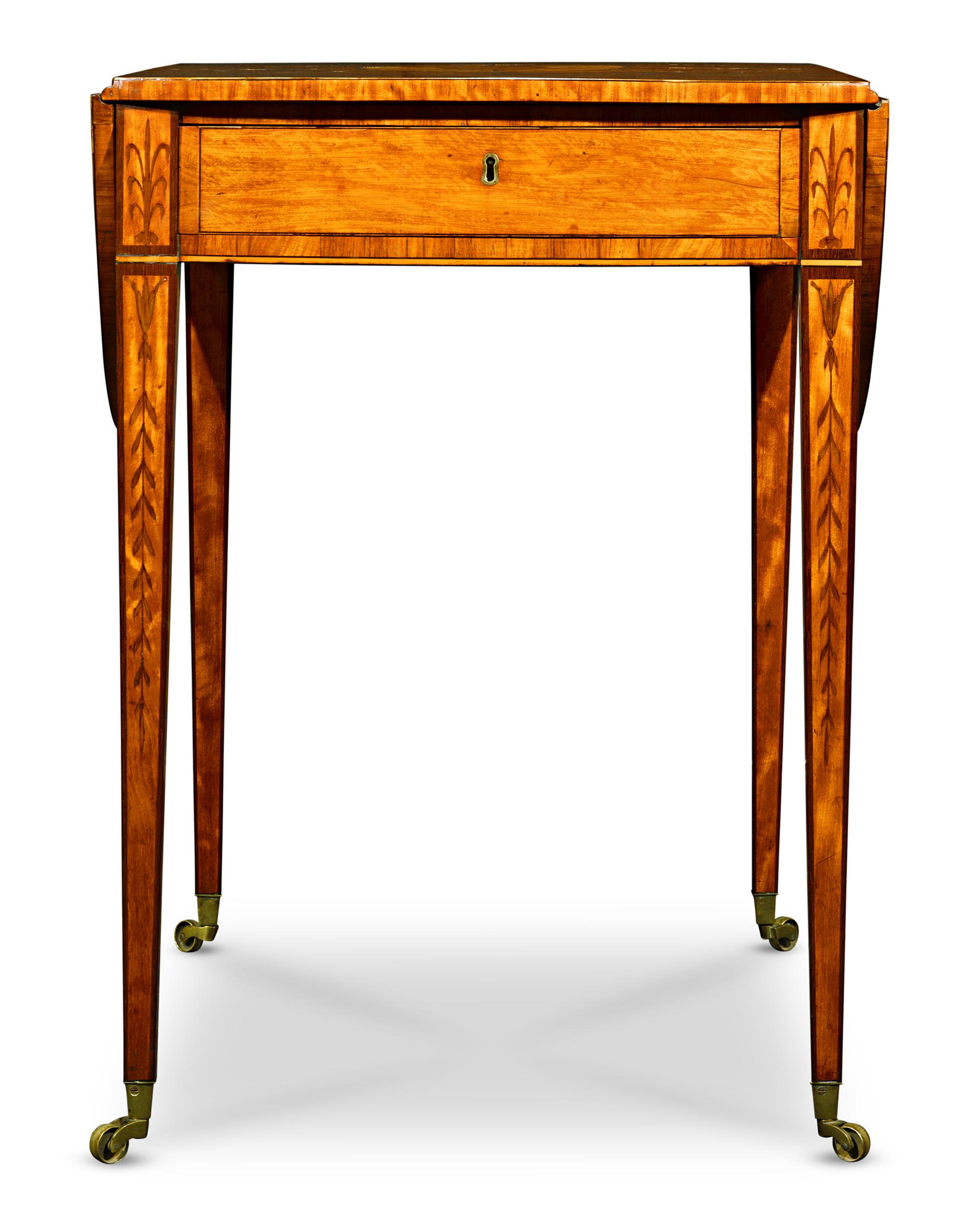 This extraordinary George III-period Pembroke table by London cabinetmakers Ince & Mayhew displays the understated sophistication of the late Georgian era. The surface of the table — including both the central panel and the signature Pembroke hinged