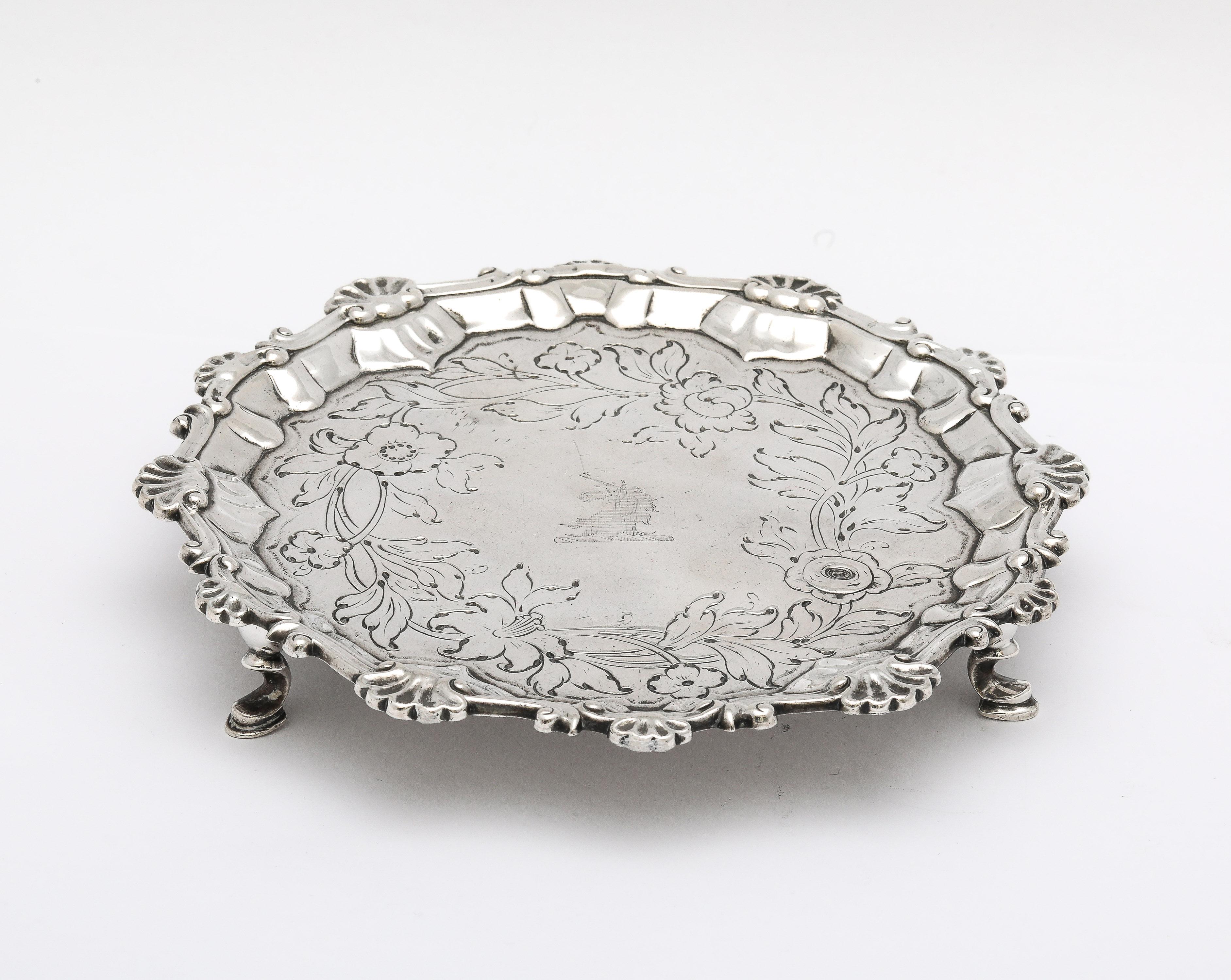 George III Period, hoof-footed sterling silver salver/tray, London, year-hallmarked for 1764, Richard Rugg - maker. The salver is designed with a scroll and shell border, and has a lovely, etched floral design which surrounds a central armorial of a