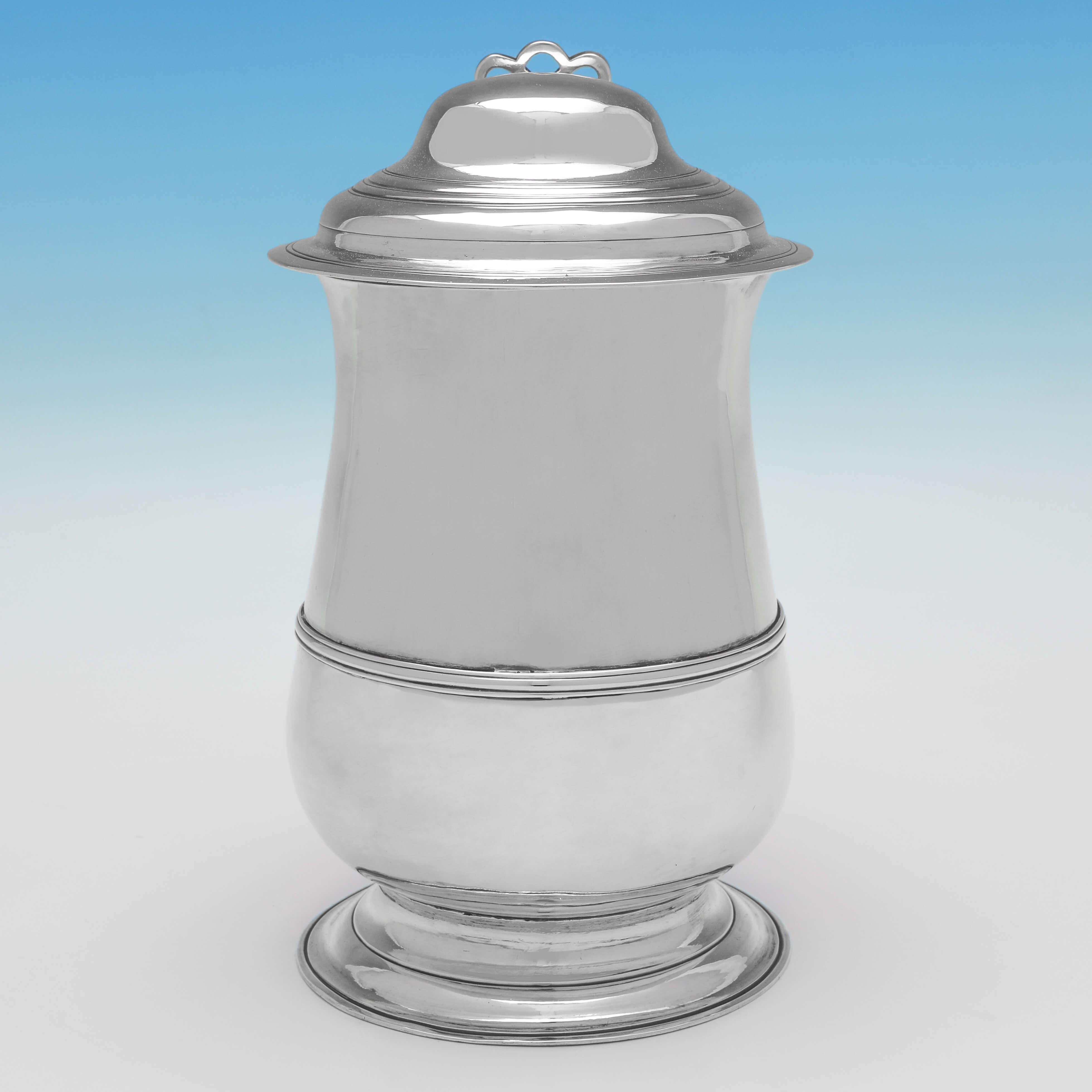 Hallmarked in London in 1773 by John Kentenber, this handsome, George III period, Antique Sterling Silver Tankard, is plain in style, featuring reed borders throughout and a dome top. 

The tankard measures 8