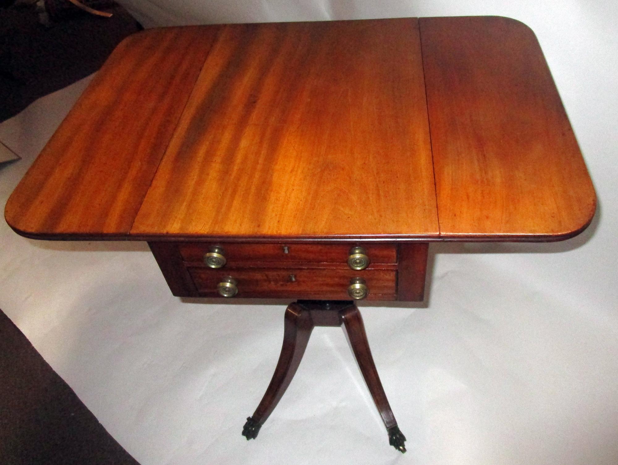 George III Sheraton period English mahogany side/work table with two shallow drawers at one end and faux drawers at other. Features include splayed legs with inlay raising to rectilinear platform with double turned columns supporting the body. Two