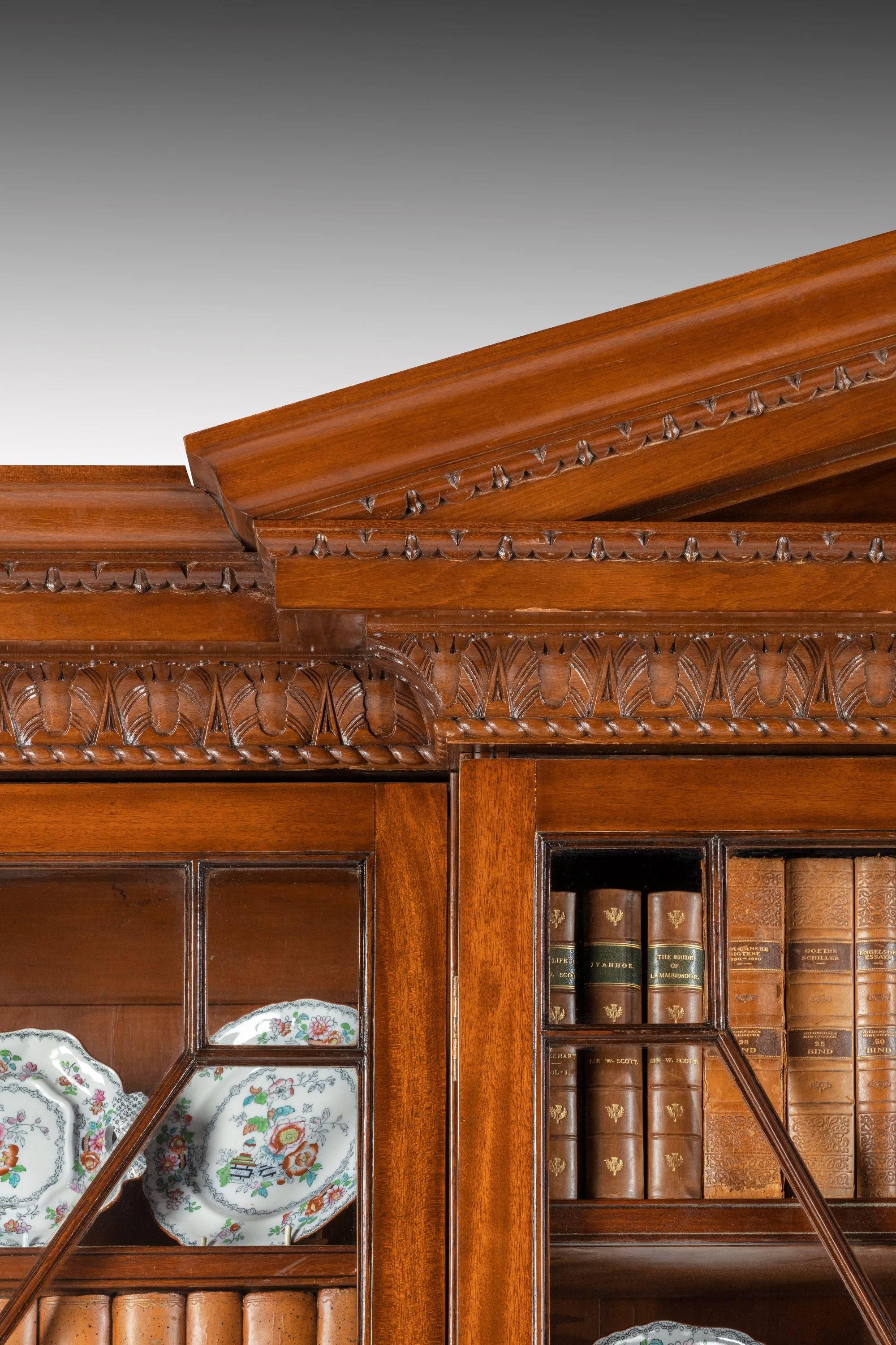 An impressive and handsome George III period mahogany bookcase with a quite exceptional and original broken arch pediment. Typical glazing of the period. Low-waisted and with excellent timbers. Restored substantially in the late 19th century.
T
    