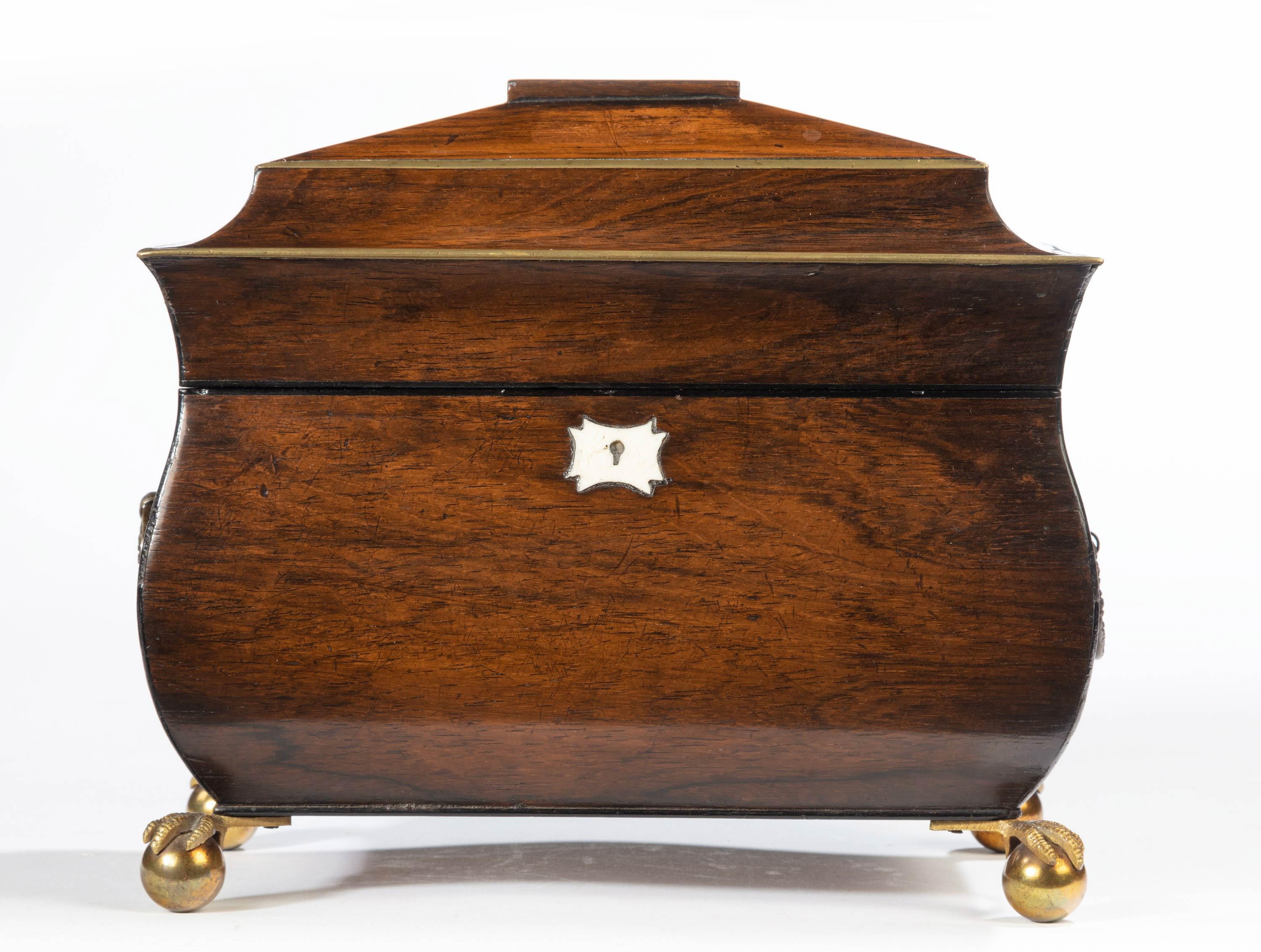 A fine and beautifully shaped George III period mahogany Bombay caddy. The top edges with very restrained corners and original handles. With original, finely cast, claw and ball feet.
  