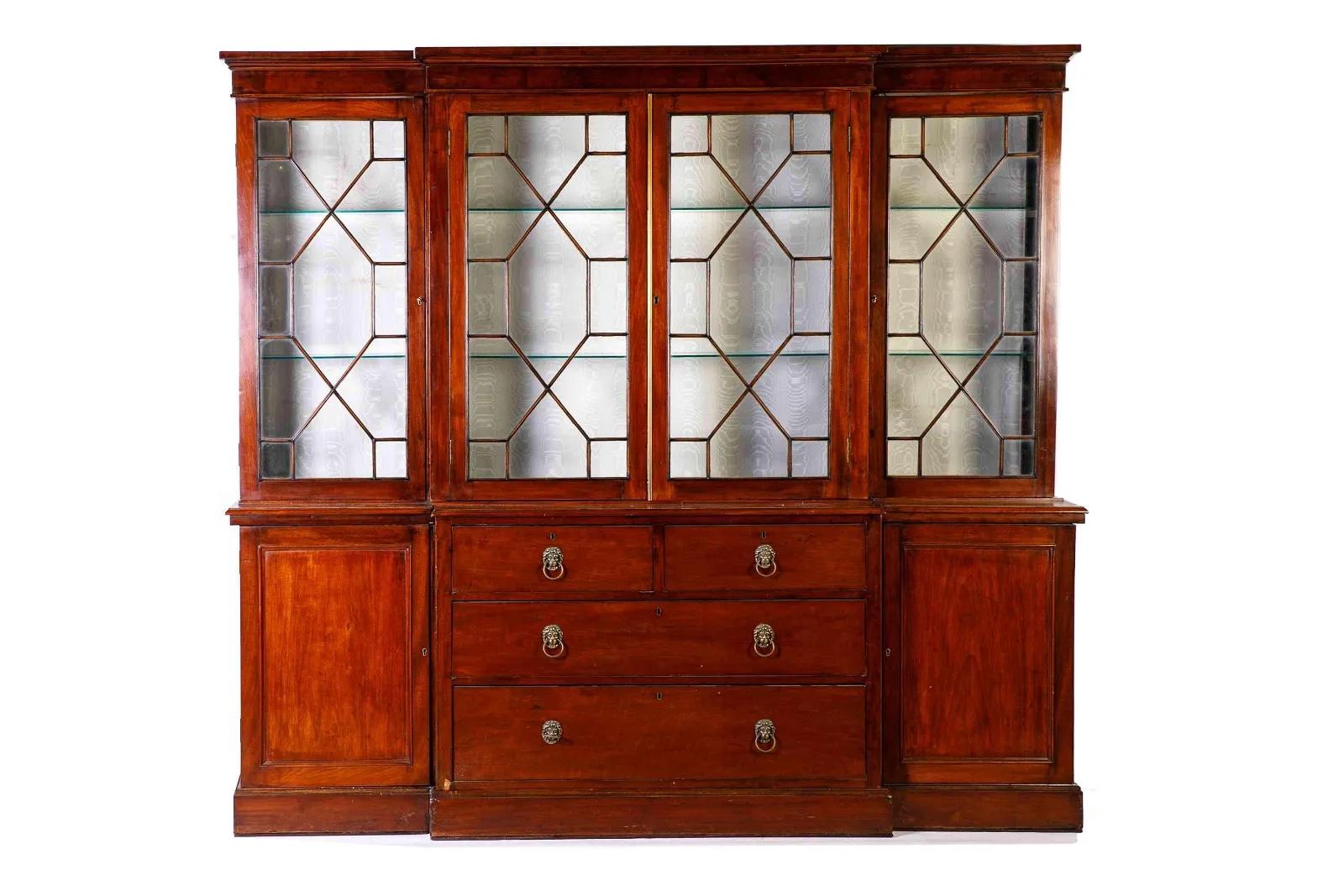 George III Period mahogany breakfront interior fitted  with desk pigeonholes, silk lining and fitted lighting.