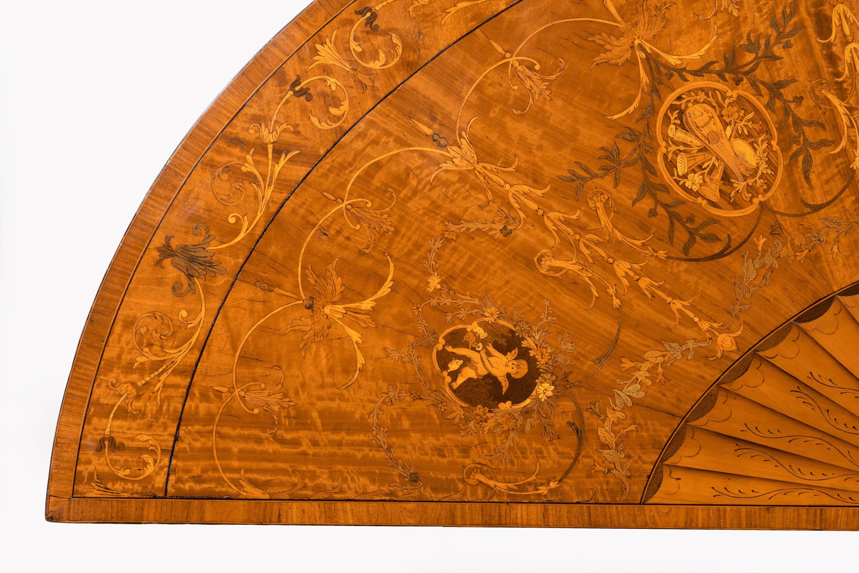 A beautifully inlaid George III period mahogany demilune pier table of complex form. Marquetry and parquetry inlays to all surfaces including Putti and a large sunburst centre section. Excellent overall condition, color and patina.
 