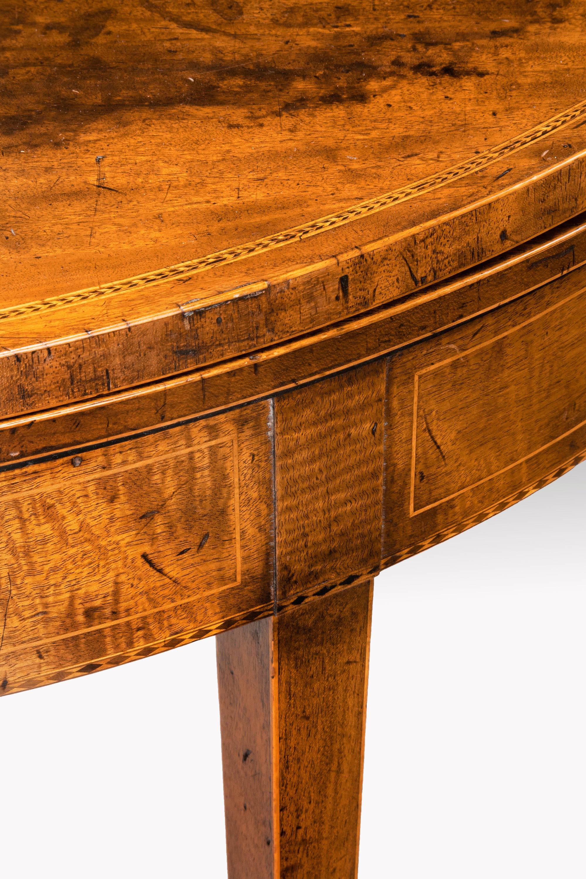 A George III period mahogany demilune tea table. Of good faded colour and patina. On square, tapering supports edged with boxwood. In good overall condition.
    