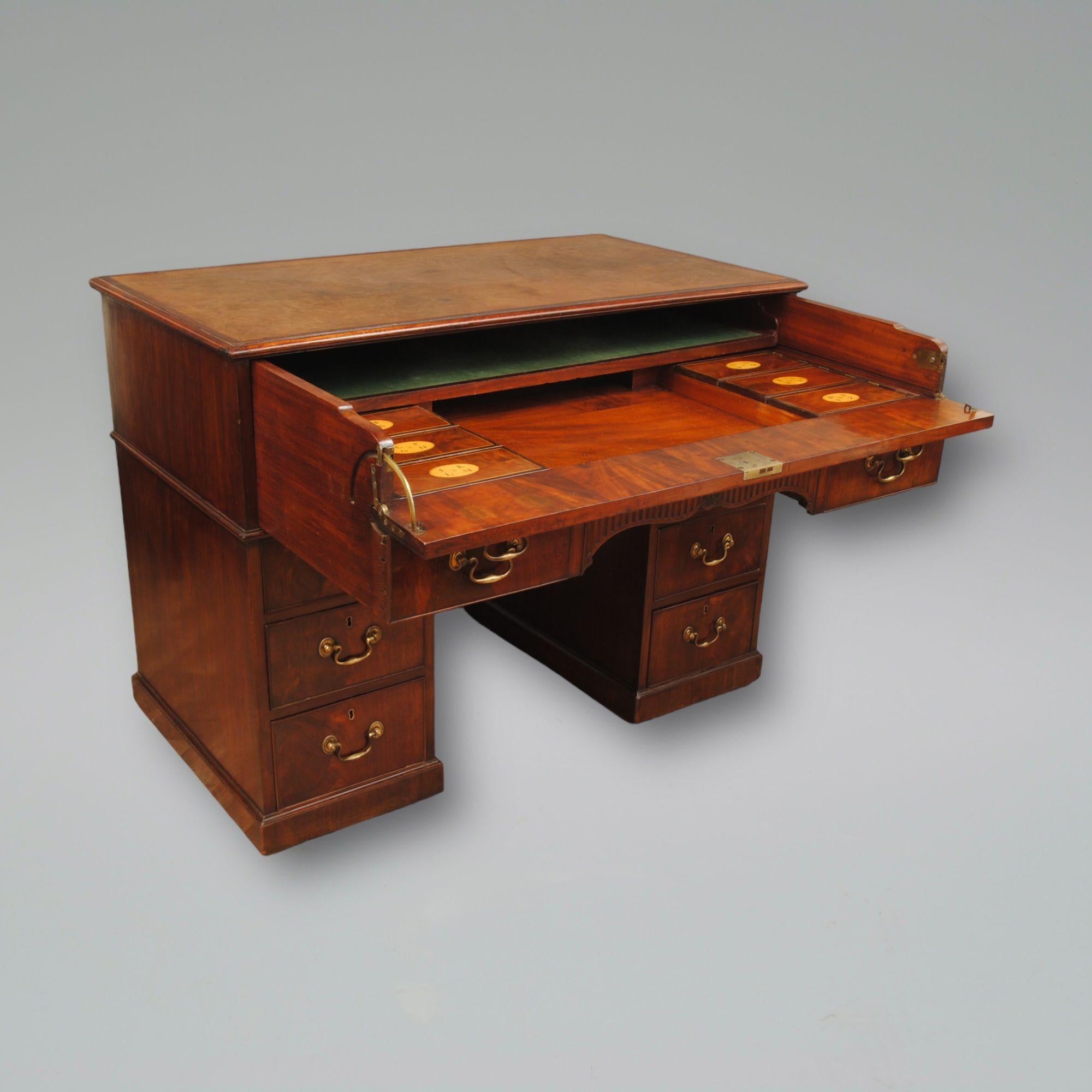 An 18th century mahogany desk or sometimes called architects desk, with fitted top drawer containing a baize lined wiring surface below which is a fitted section contains alphabet inlaid letter boxes The double top drawer slides out on hidden