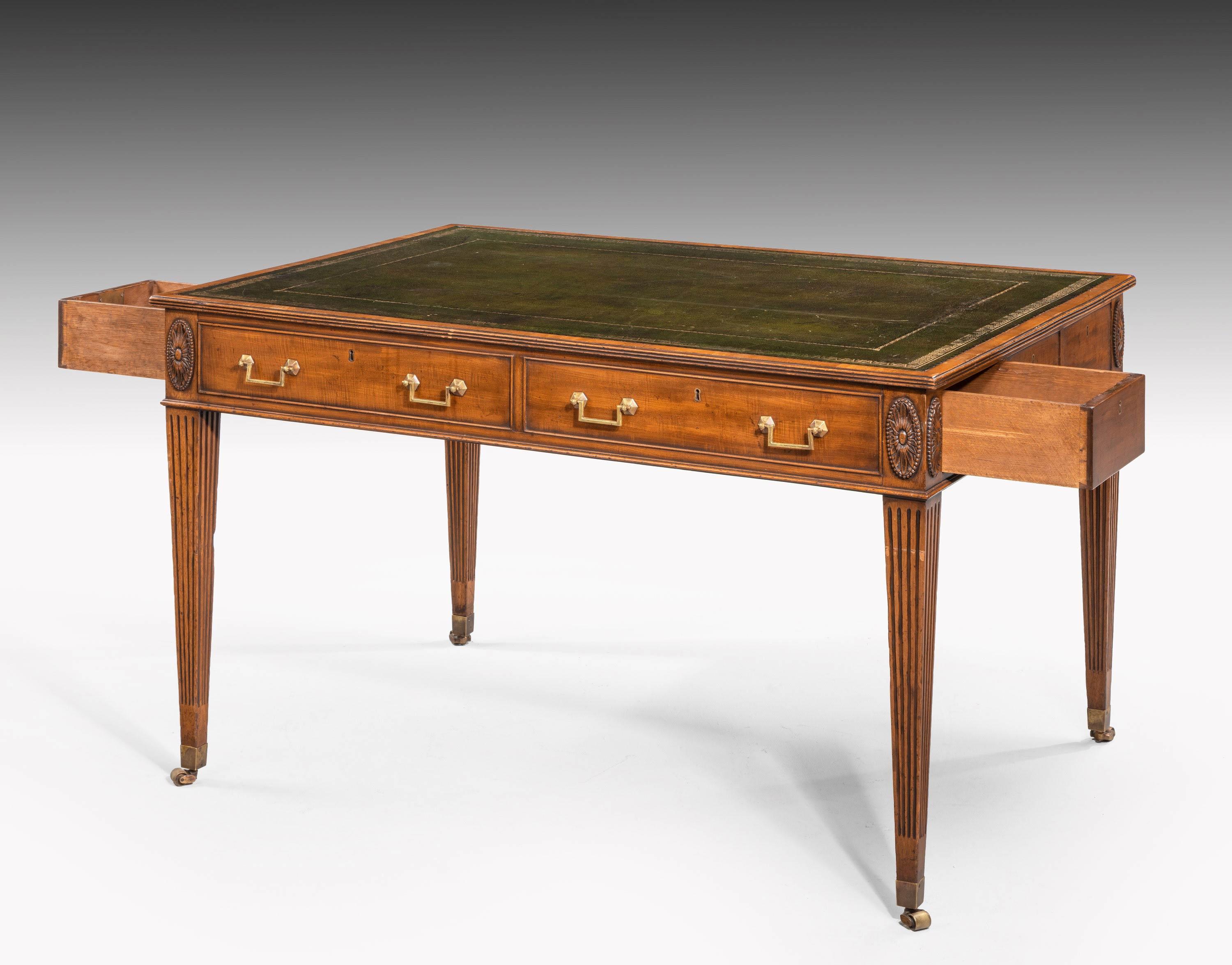 A very fine quality George III period mahogany library table on beautifully carved, beaded, supports terminating in the original shoes and castors. The drawers retaining their original finely cast brass handles. The top of the supports with very