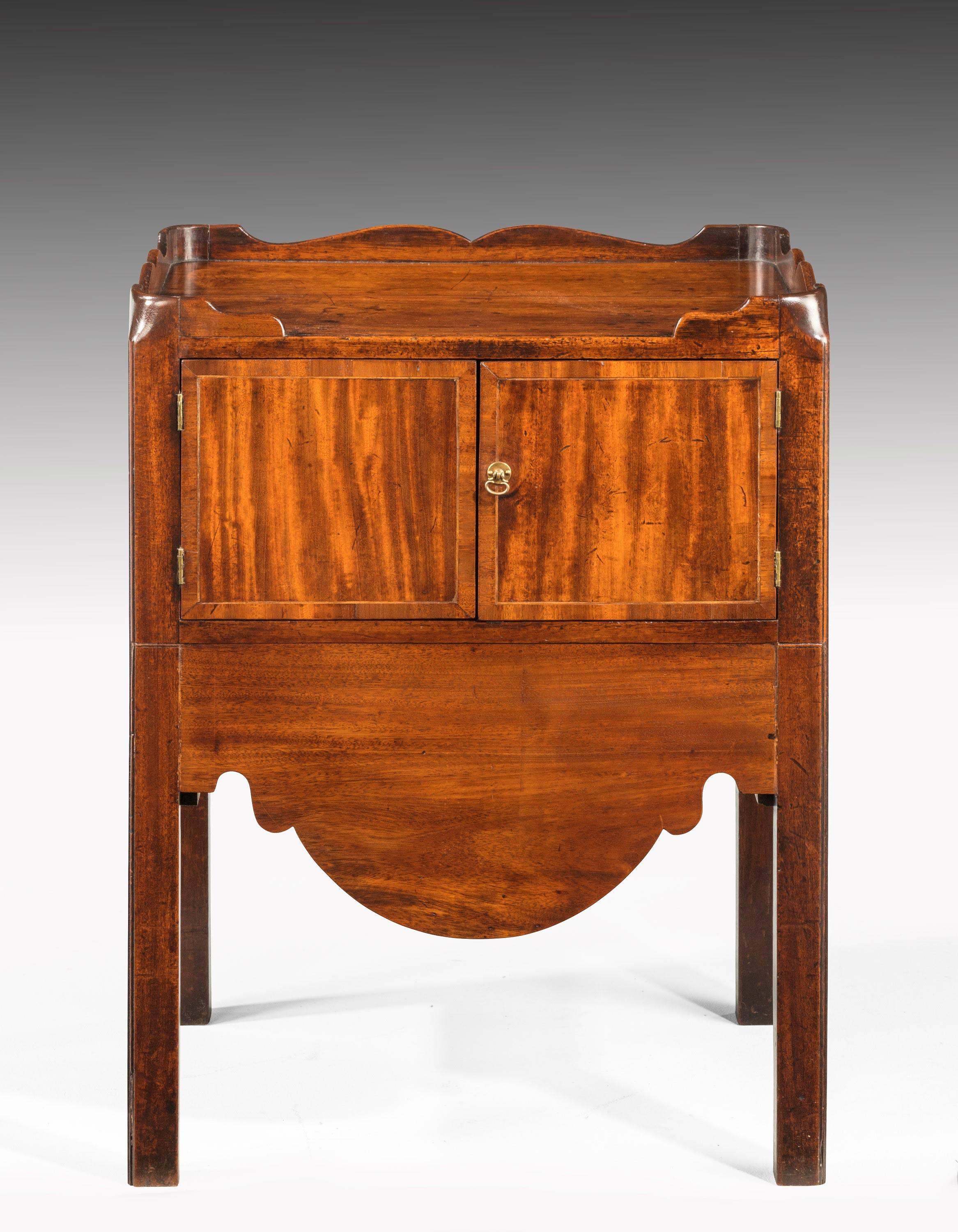A George III period mahogany tray top commode. The doors crossbanded in mahogany with line edging. Square chamfered supports.
