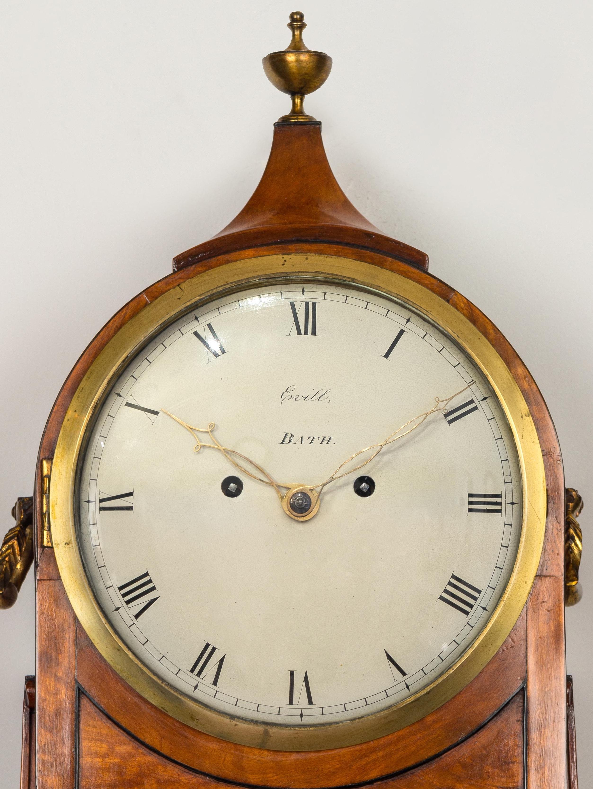 An imposing antique George lll period satinwood bracket clock, on matching wall bracket, by this reputable firm of West Country clockmakers. The figured veneered case is of bold classical style and has crisply carved side volutes, swept top with