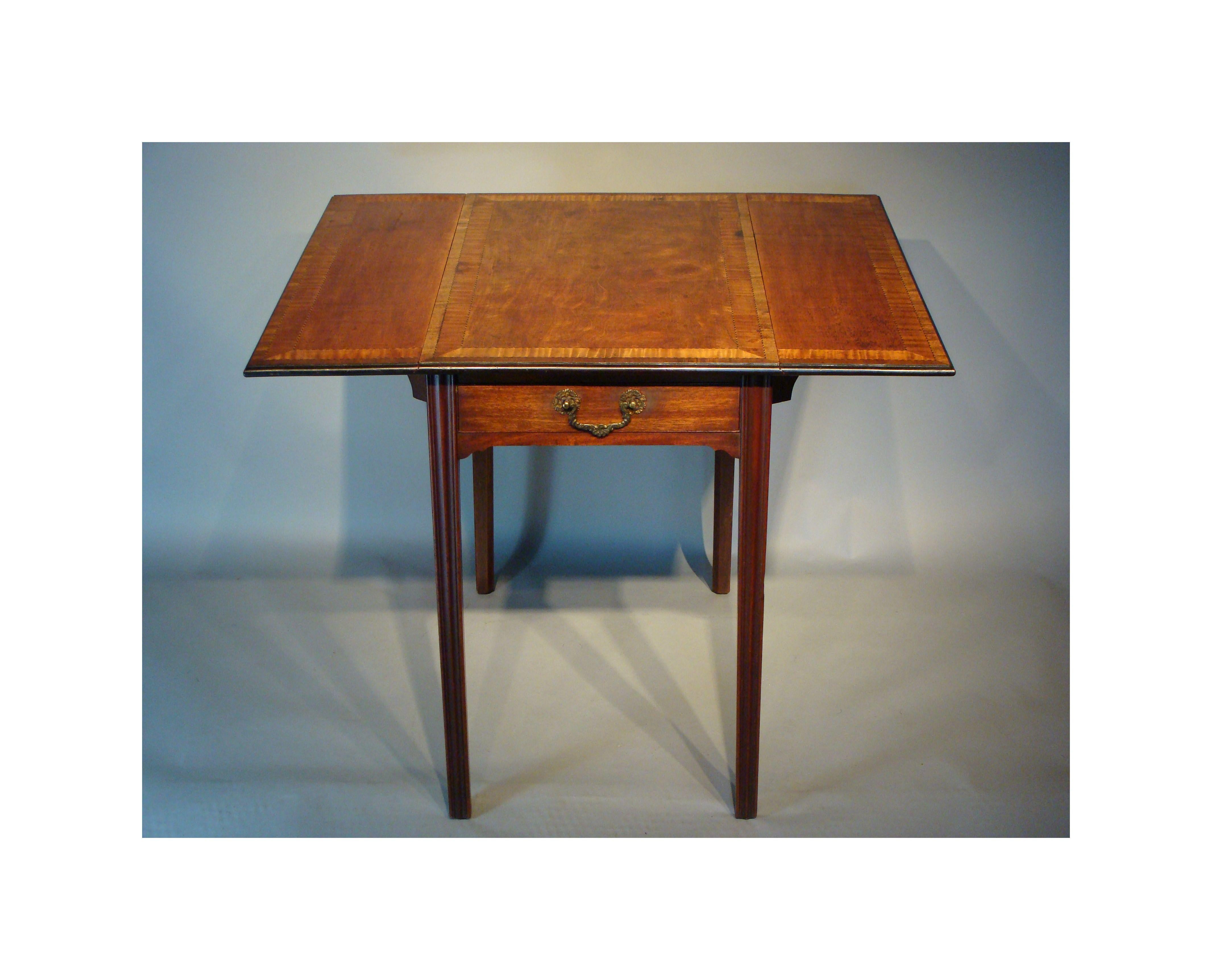 A late 18th century satinwood Pembroke table of very good rich color. 
George III period.

The top crossbanded in satinwood, bordered with fine lozenges of ebony stringing.
The edges ebonized with narrow mahogany crossbandings.
Raised on