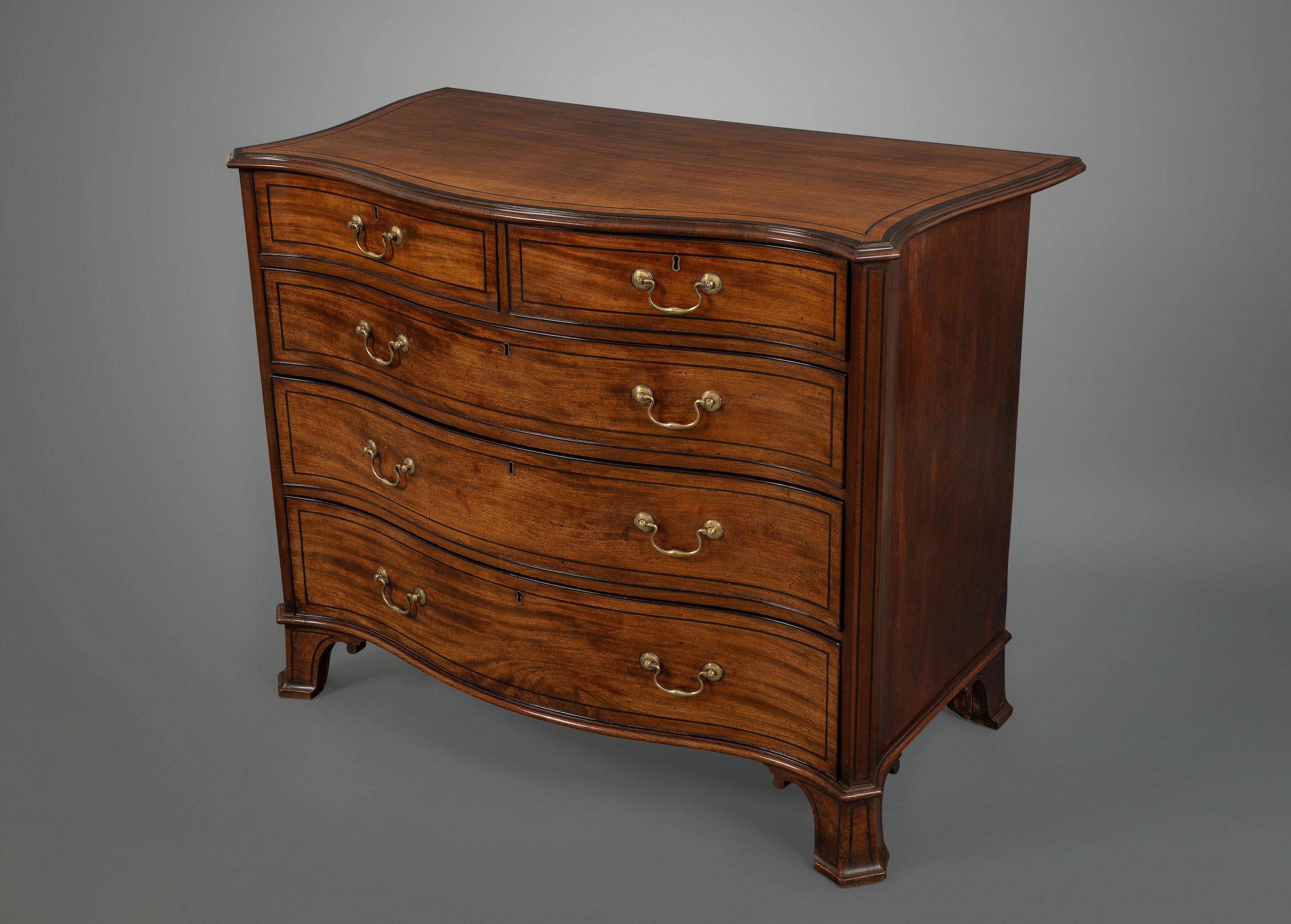 A very fine quality English George III period serpentine fronted chest of drawers executed in selected faded sabicu wood, the shaped sides being in mahogany, the drawers, top and feet being inlaid with ebony, the drawers retaining all the original