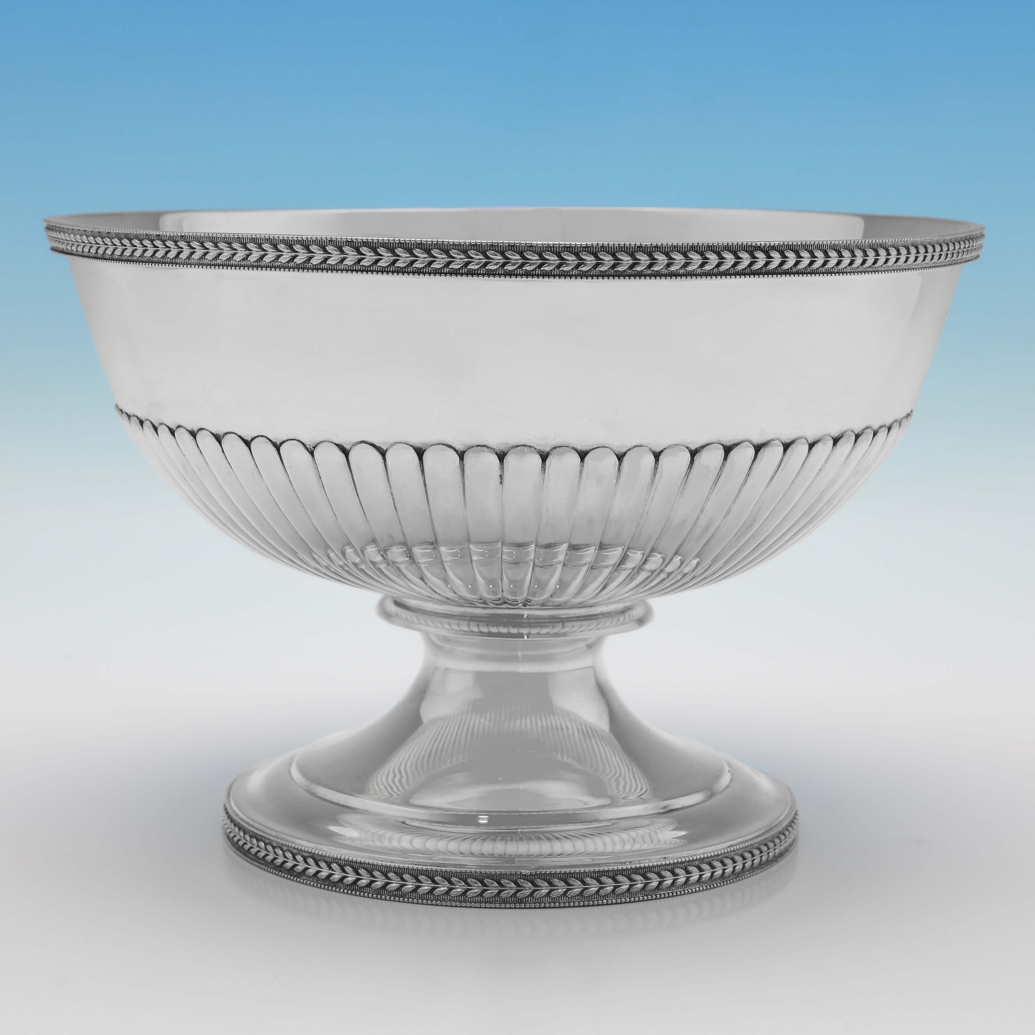 Hallmarked in London in 1803 by John Emes, this handsome, George III period, Antique Sterling Silver Bowl, stands on a pedestal foot, and features half fluting, and rope borders. 

The bowl measures 5.5