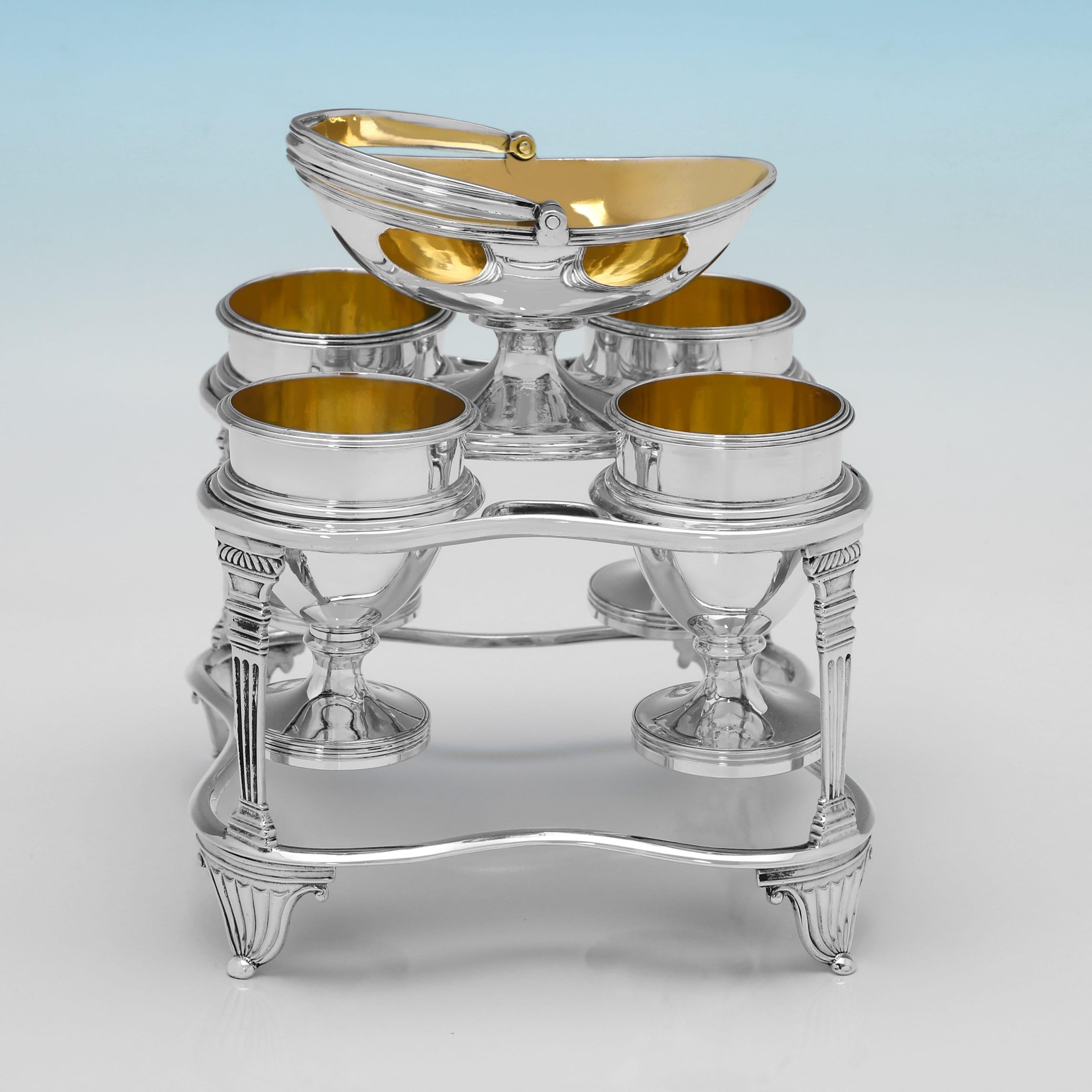 Hallmarked in London in 1808 by Emes & Barnard, this handsome, Antique, George III period, Sterling Silver Egg Cruet, is in the Neoclassical taste, and holds four egg cups and a central salt cellar. The egg cruet measures 7.5