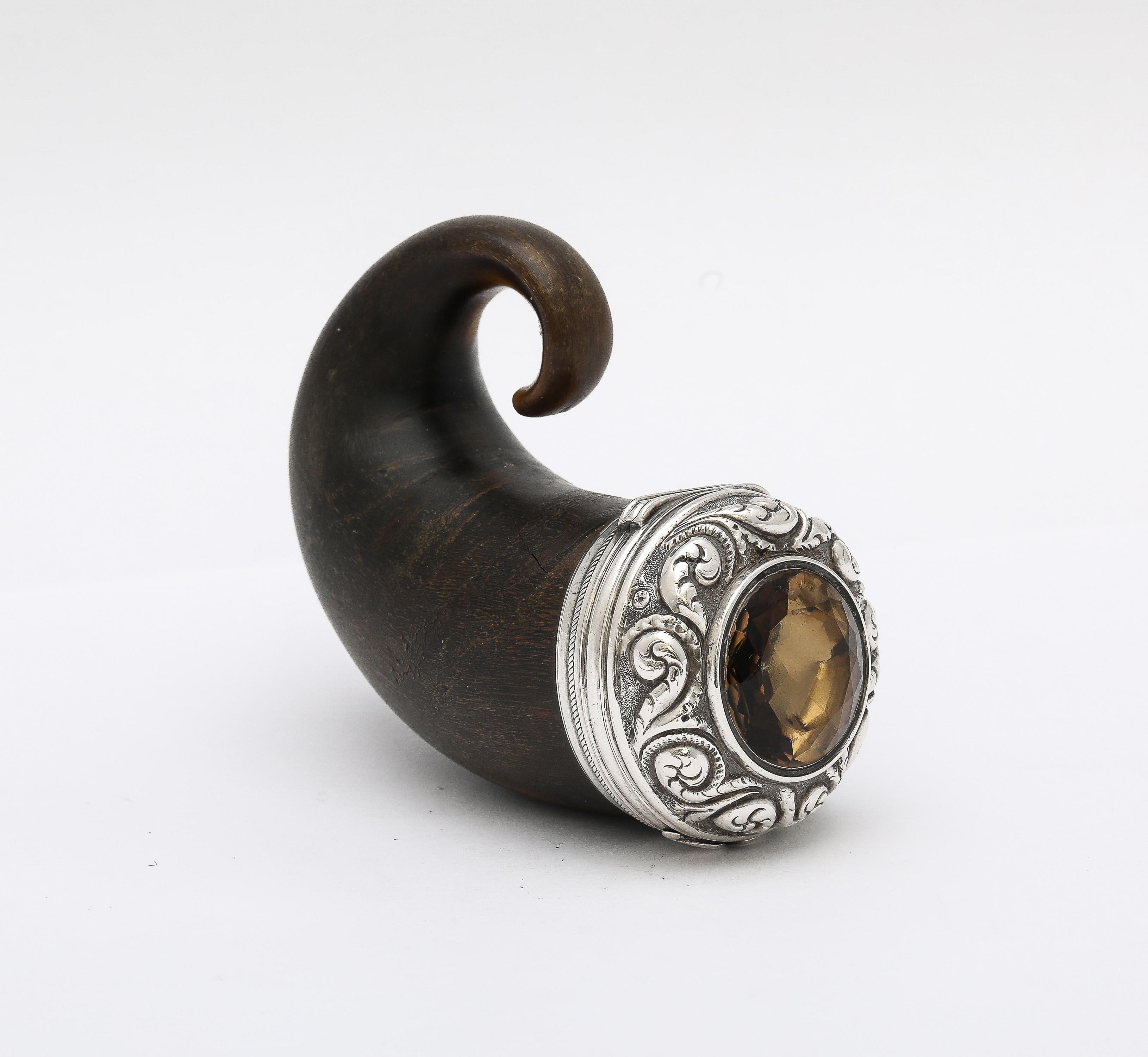 George III Period, sterling silver-mounted (unmarked but tested), ram's horn snuff mull with hinged lid. The lid is inset with a central, faceted cairngorm stone which is surrounded by the sterling silver scroll designed  mount, Scotland, Ca. 1810.