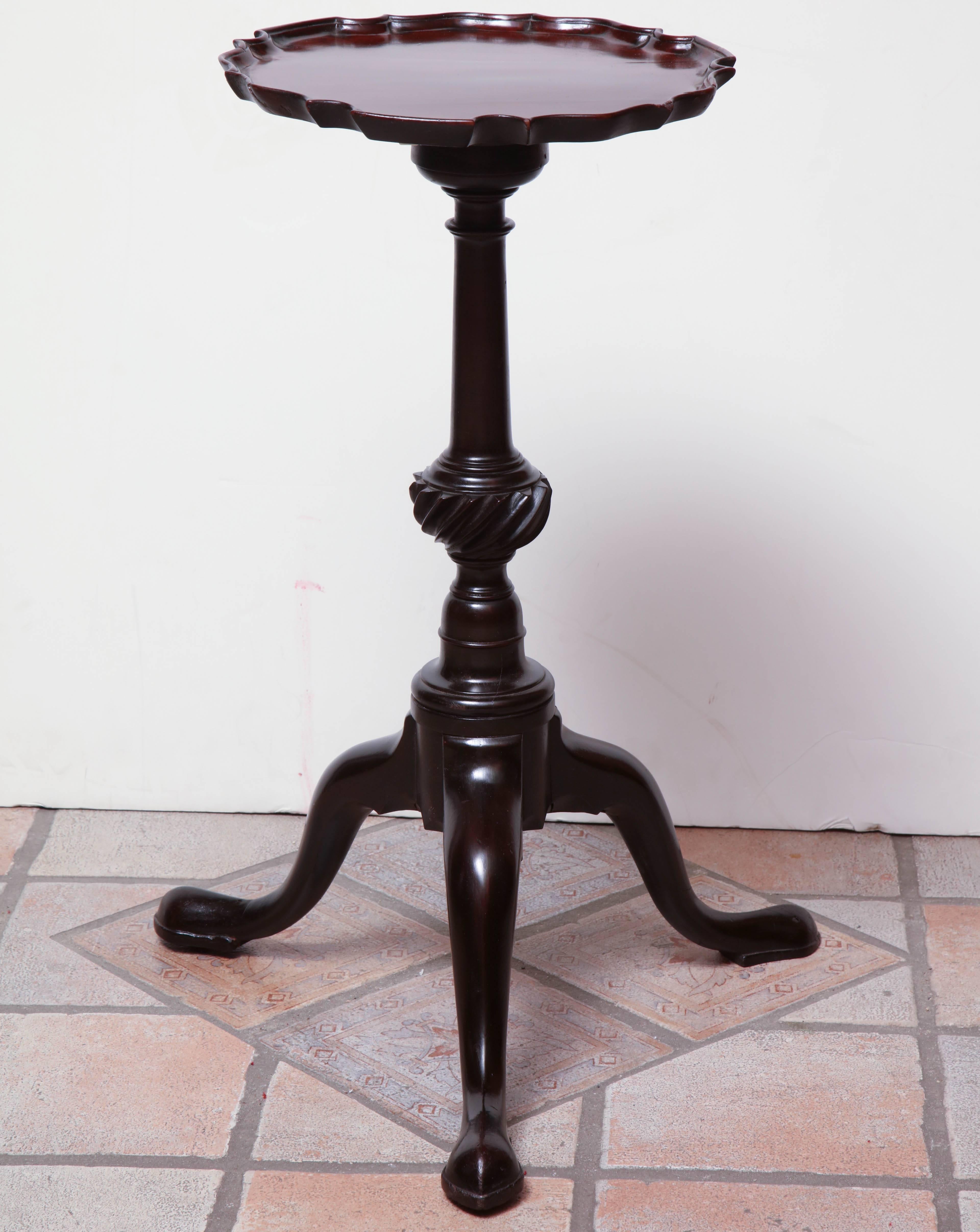 George III mahogany carved piecrust wine table with a carved swirl urn form column pedestal on cabriole legs and pad feet.