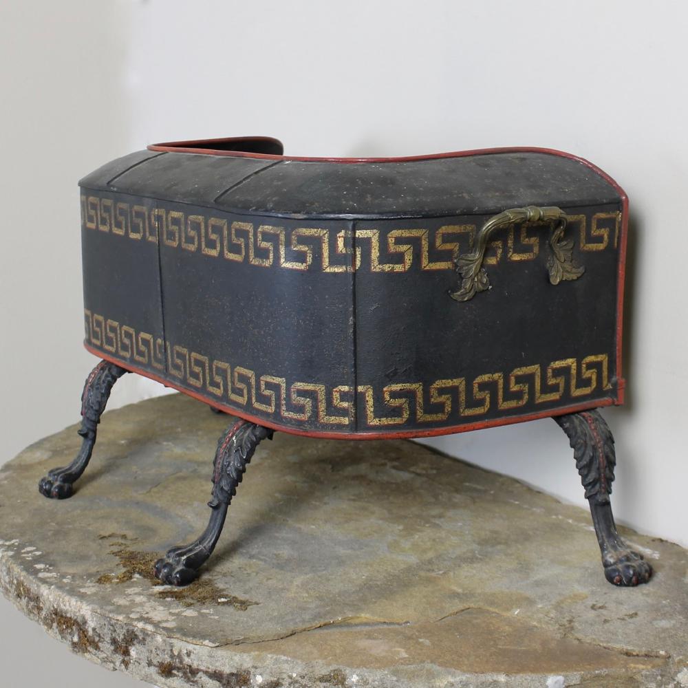 A rare, Regency, original painted tole plate warmer. Standing on lions paw feet, the body with its original carrying handles and gilt, Greek key decoration. In very good condition.

English circa 1820.